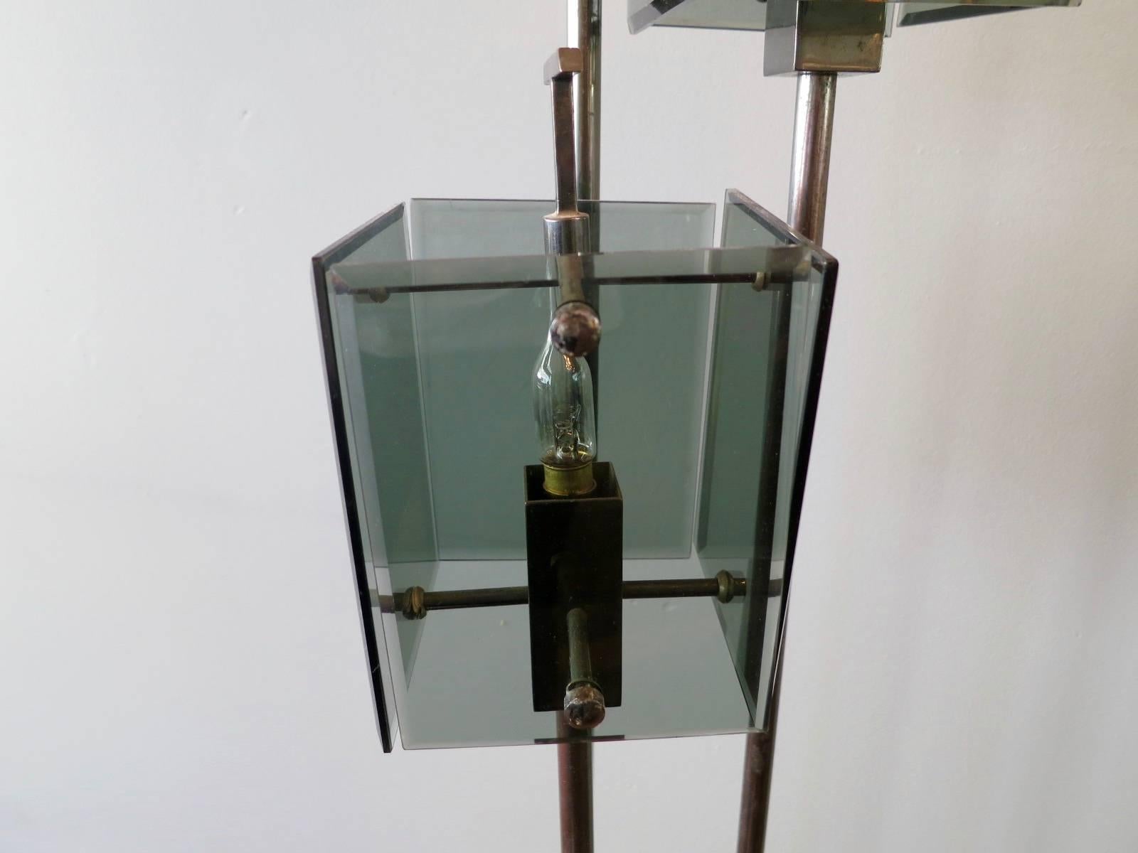 An Italian floor lamp in the manner of crystal Arte, with bevelled green glass diffusers, marble base with brass switch and bronze finish stem and accents.