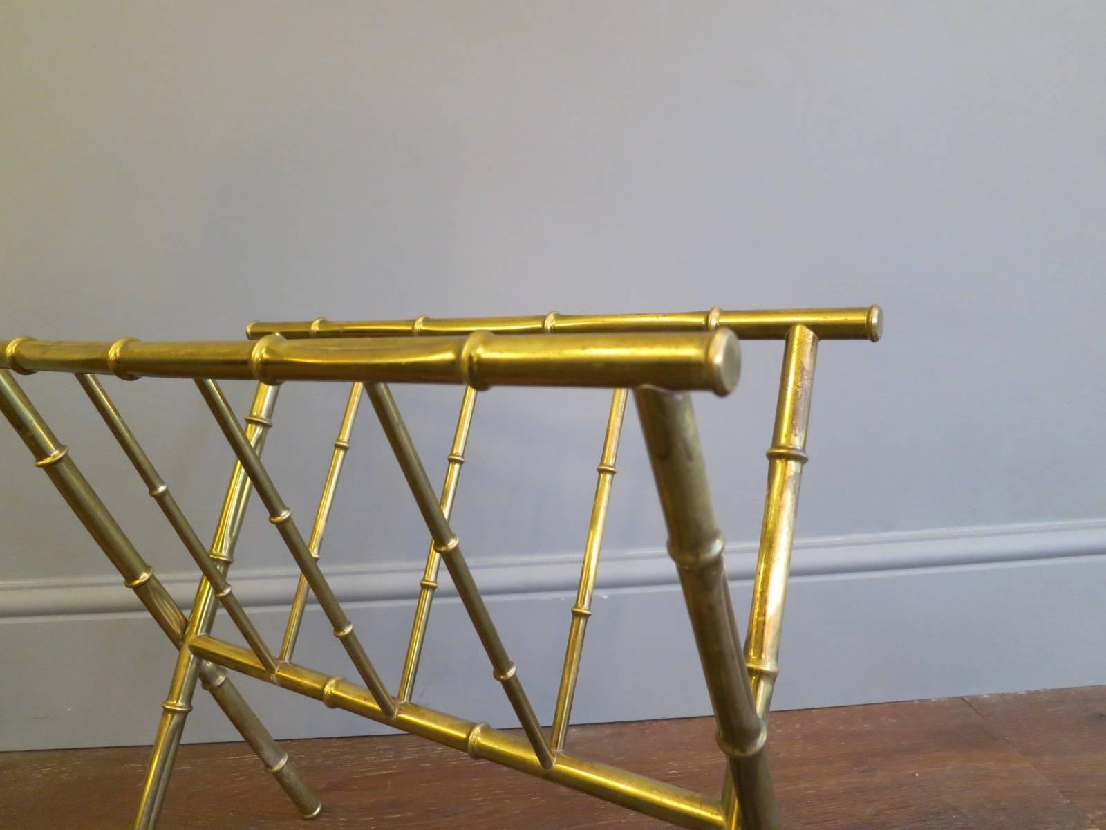 A brass faux bamboo magazine stand in the manner of Bagues.