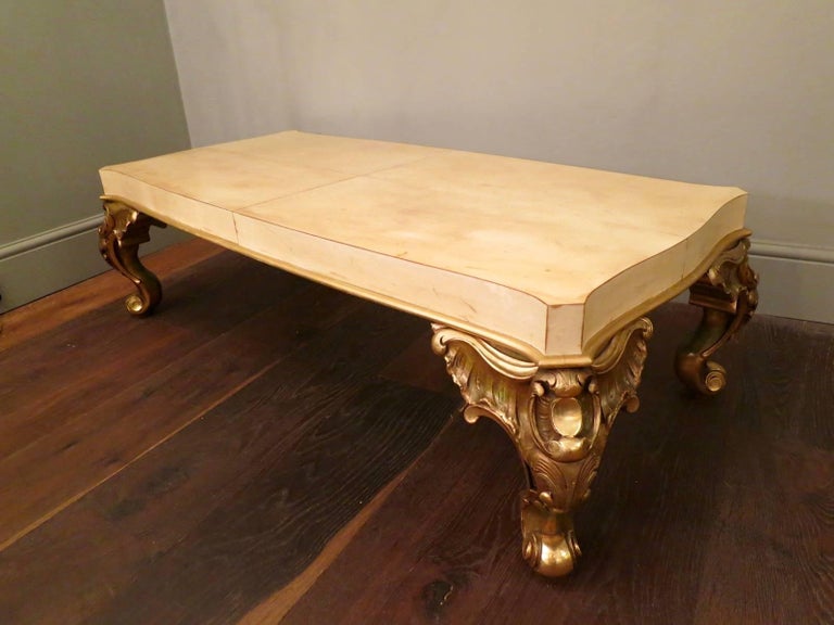 A very good quality table by Maison Jansen, with elaborate gold gilt supports in the Rococo manner, and a shaped top in parchment. Stamped Jansen underneath.