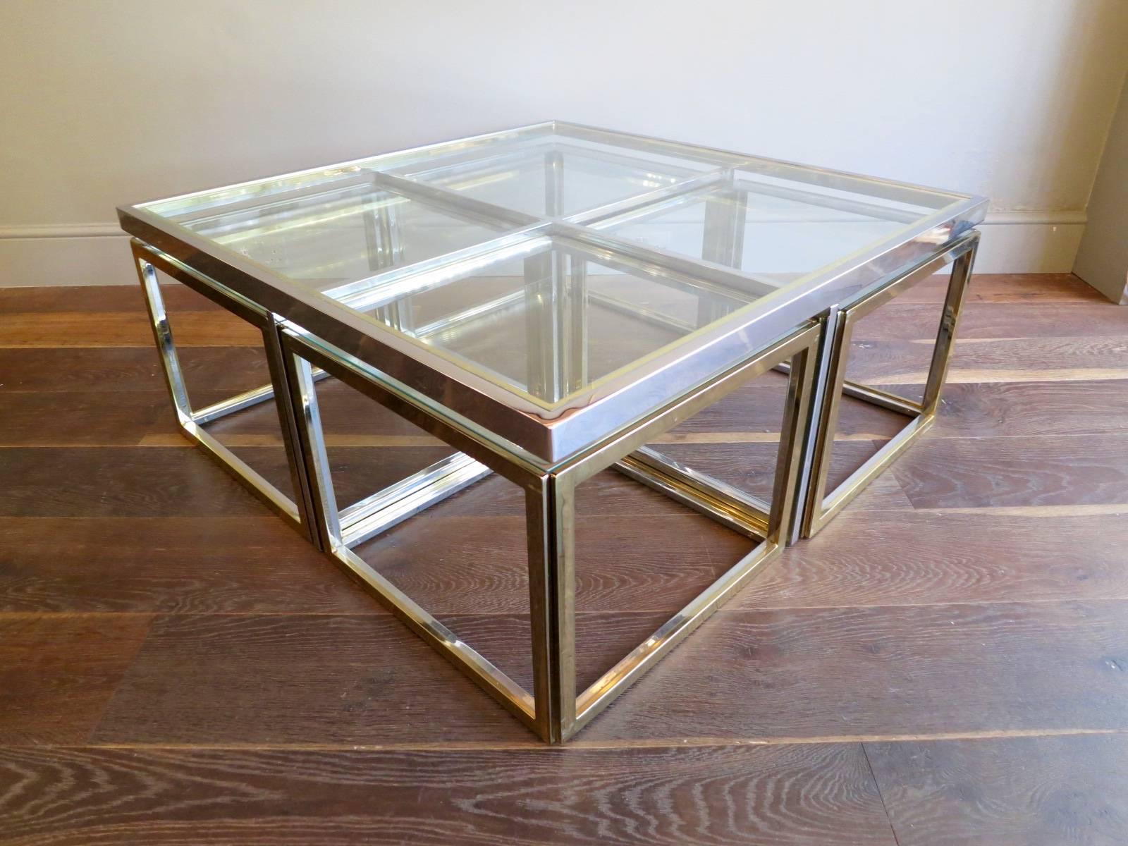 A large square cocktail table with four cubed side tables inside, all in brass and chrome. A very versatile and functional table. Designed by Jean Charles Paris 

The side tables sizes are 50.75 cm x 50.75 cm x 38 cm.