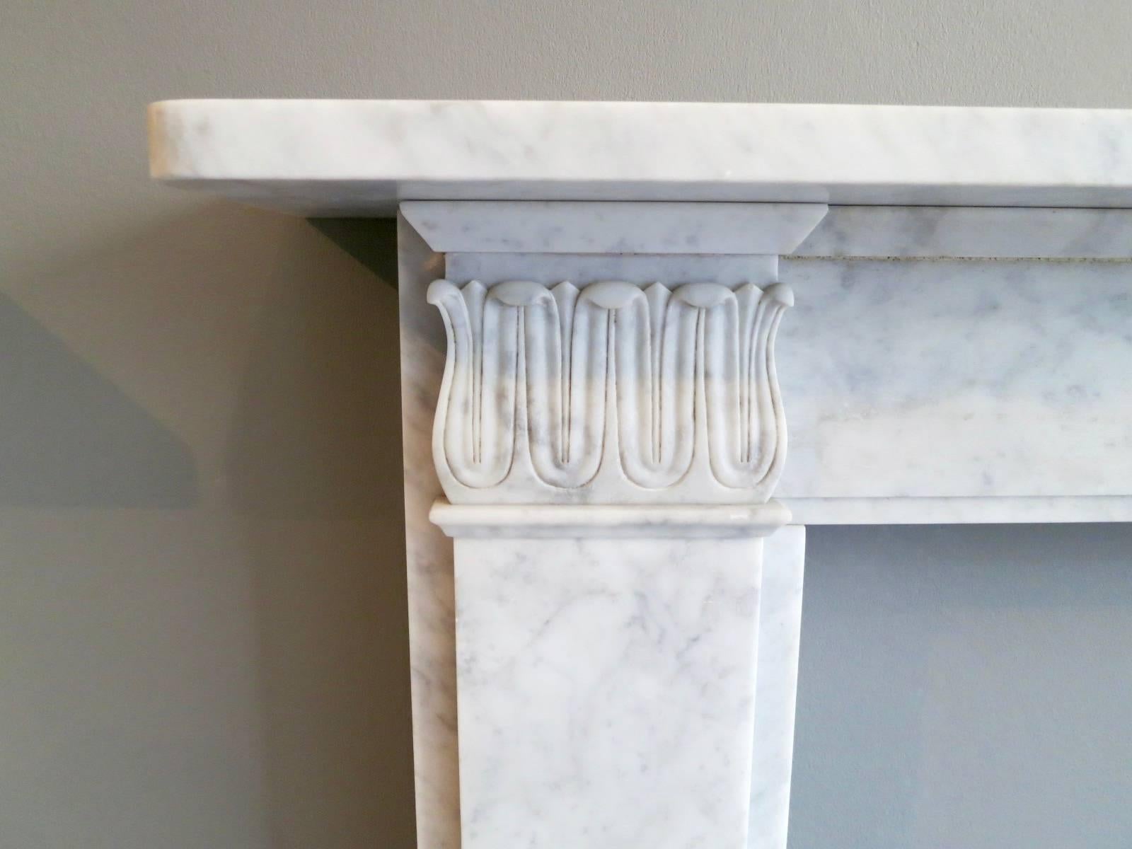 A slightly aged Regency style fireplace in Carrara marble. A good quality reproduction piece, available in custom sizes and other marbles.

Opening size 91.5cm x 91.5cm 