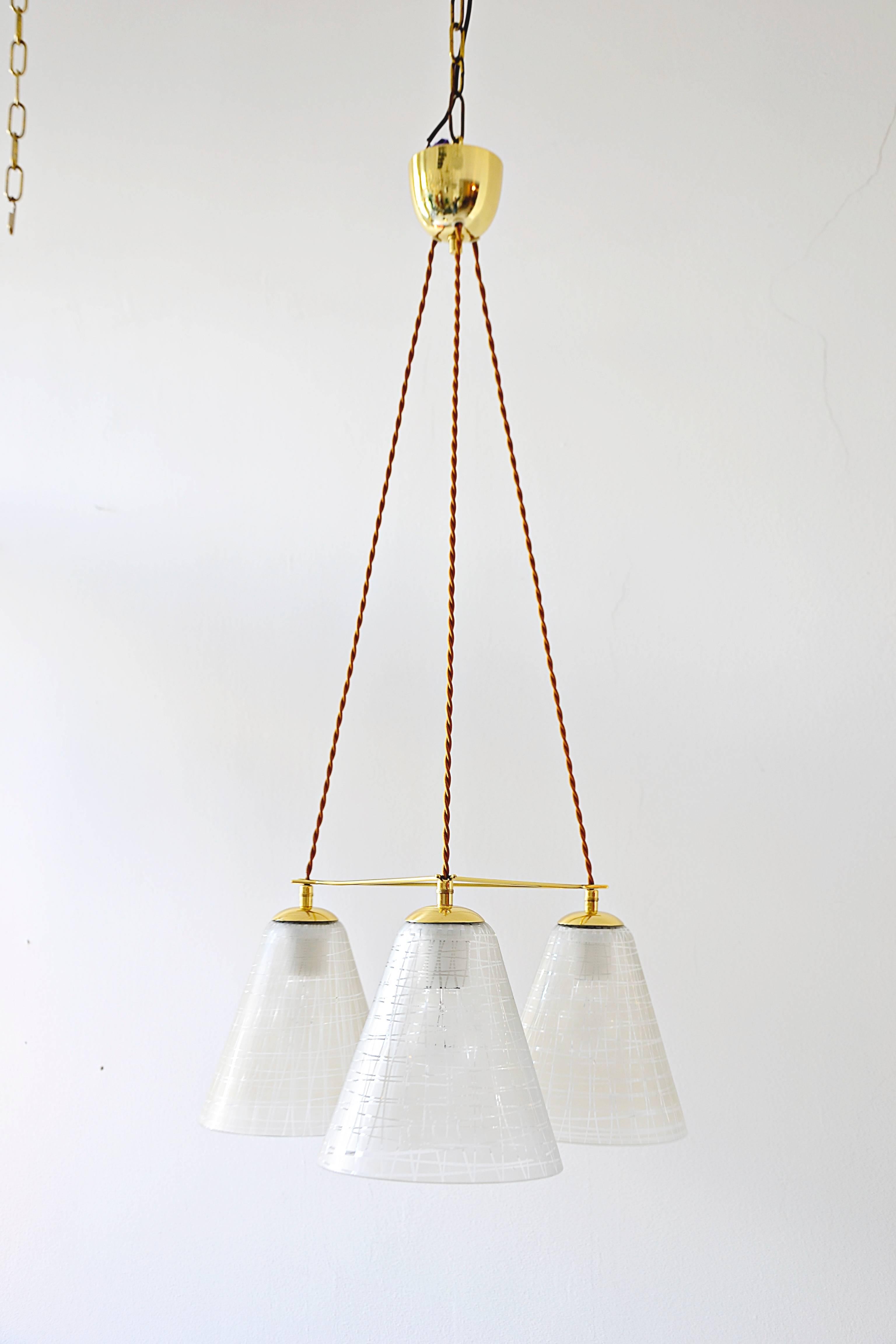 Triangular chandelier 1960s with beautiful original glass shades
polished and stove enameled.