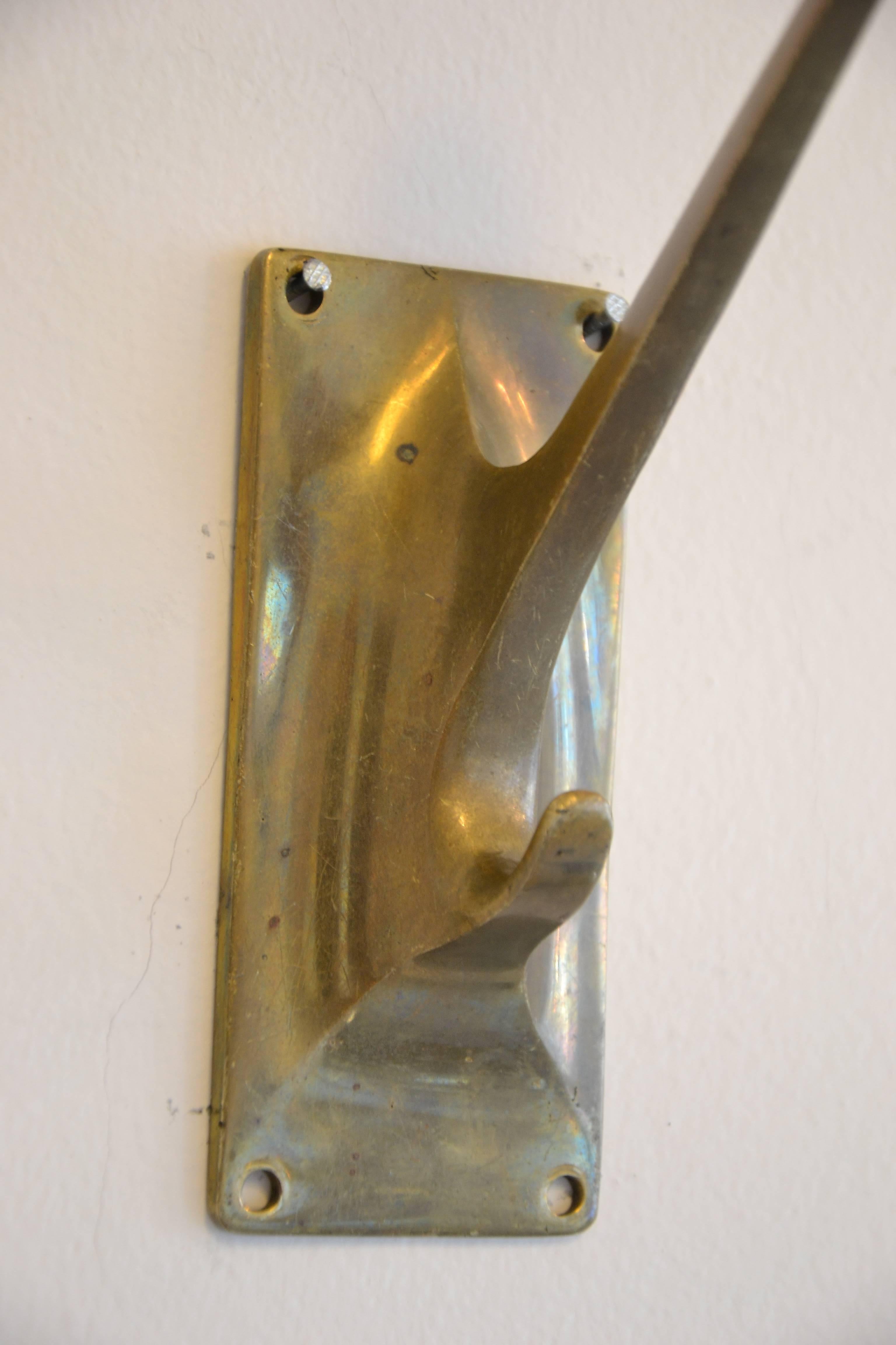 Six wall hooks by Adolf Loos.
Designed in 1909 for the tailor salon Knize in Vienna. Brass. 
Two pieces original condition and at four-piece everything is original condition only the stalk is repaired and polished.
