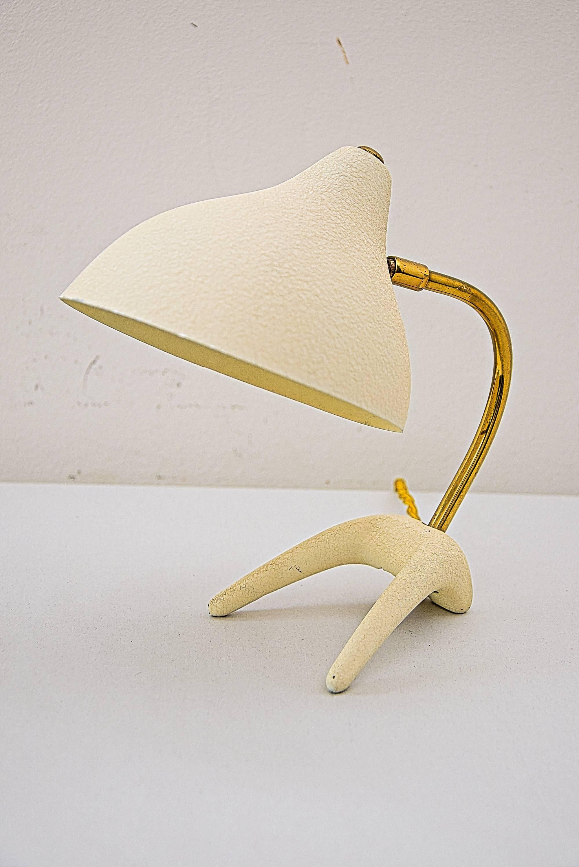 Small table lamps by Louis Kalff for Philips.
Elegant small 1950s table lamp with so called "Crow's foot" base, brass stem and light beige lacquered shade.