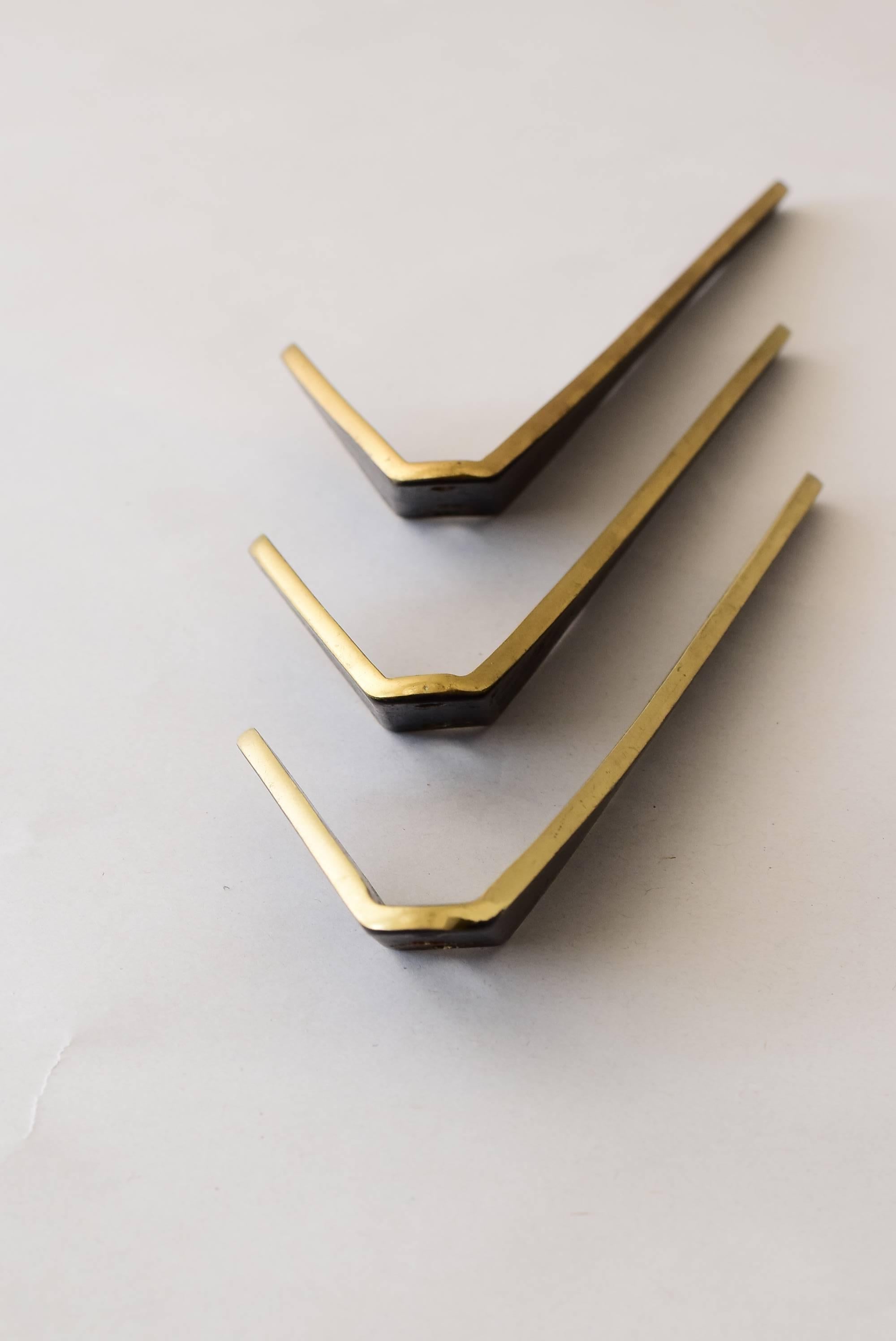 Three asymmetric modernist brass wall hooks by Walter Bosse, Austria, 1950s.

Original condition.