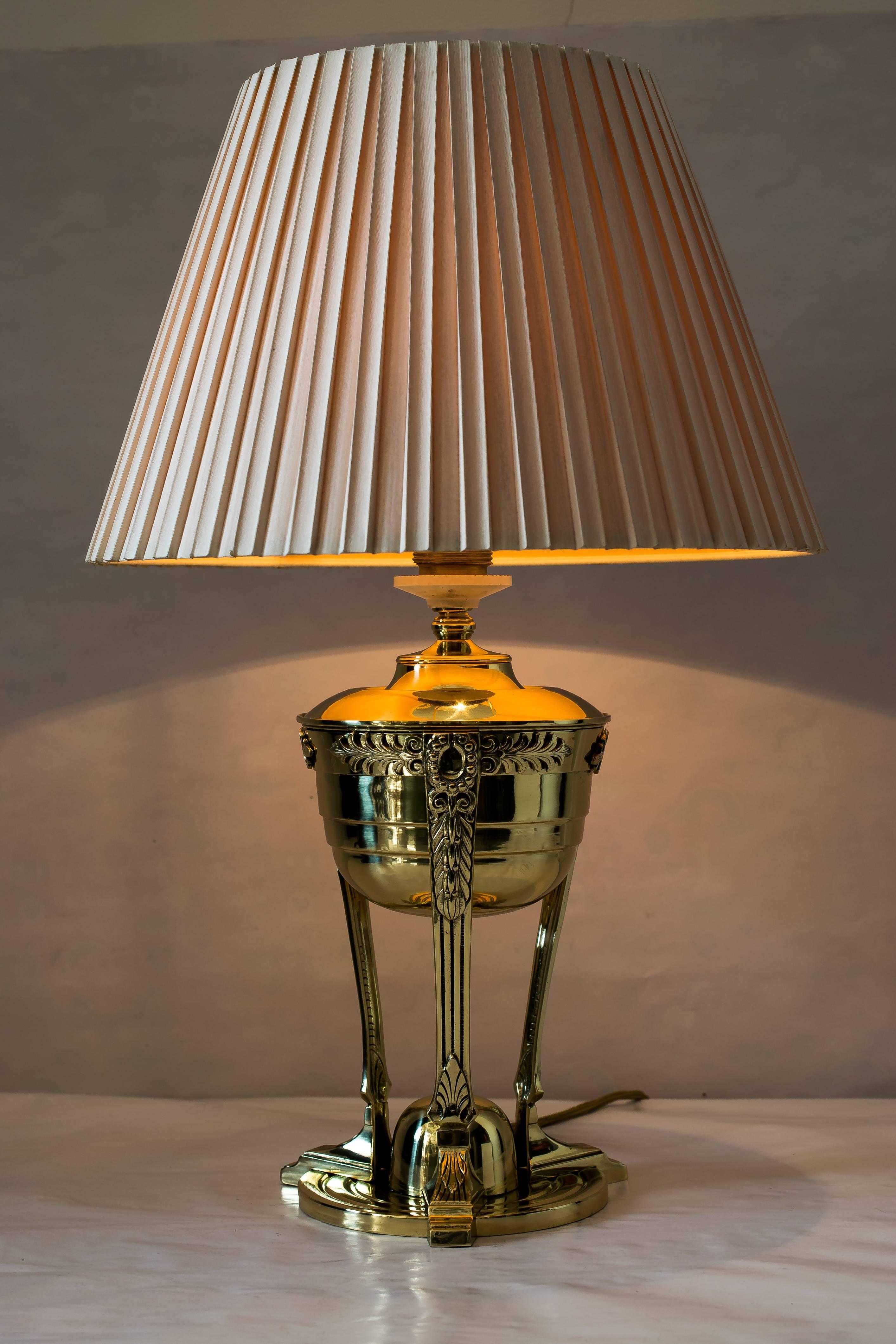 Art Nouveau table lamp with original fabric shade
polished and stove enamelled.