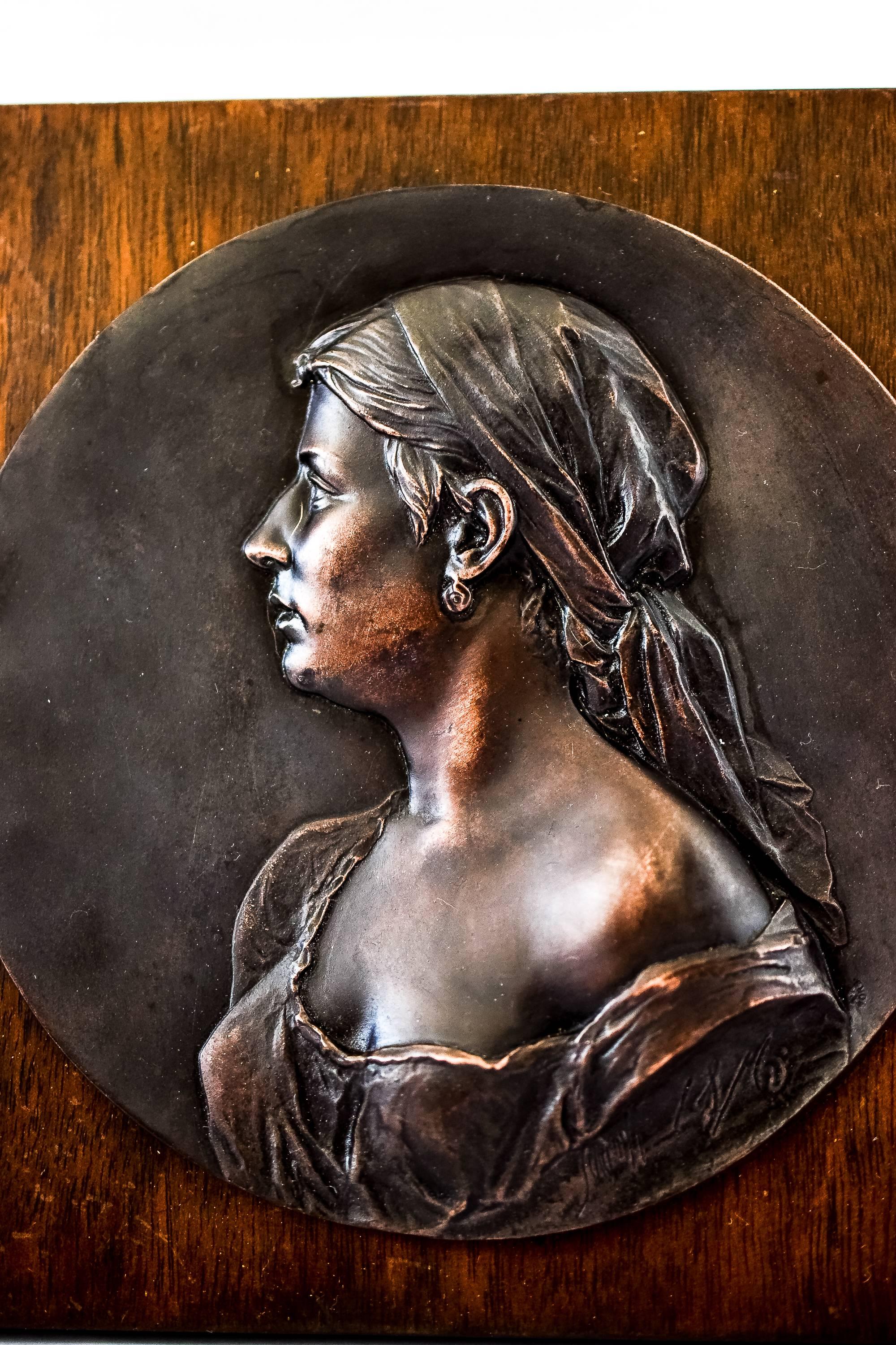 Bronze relief on wood
Original condition.