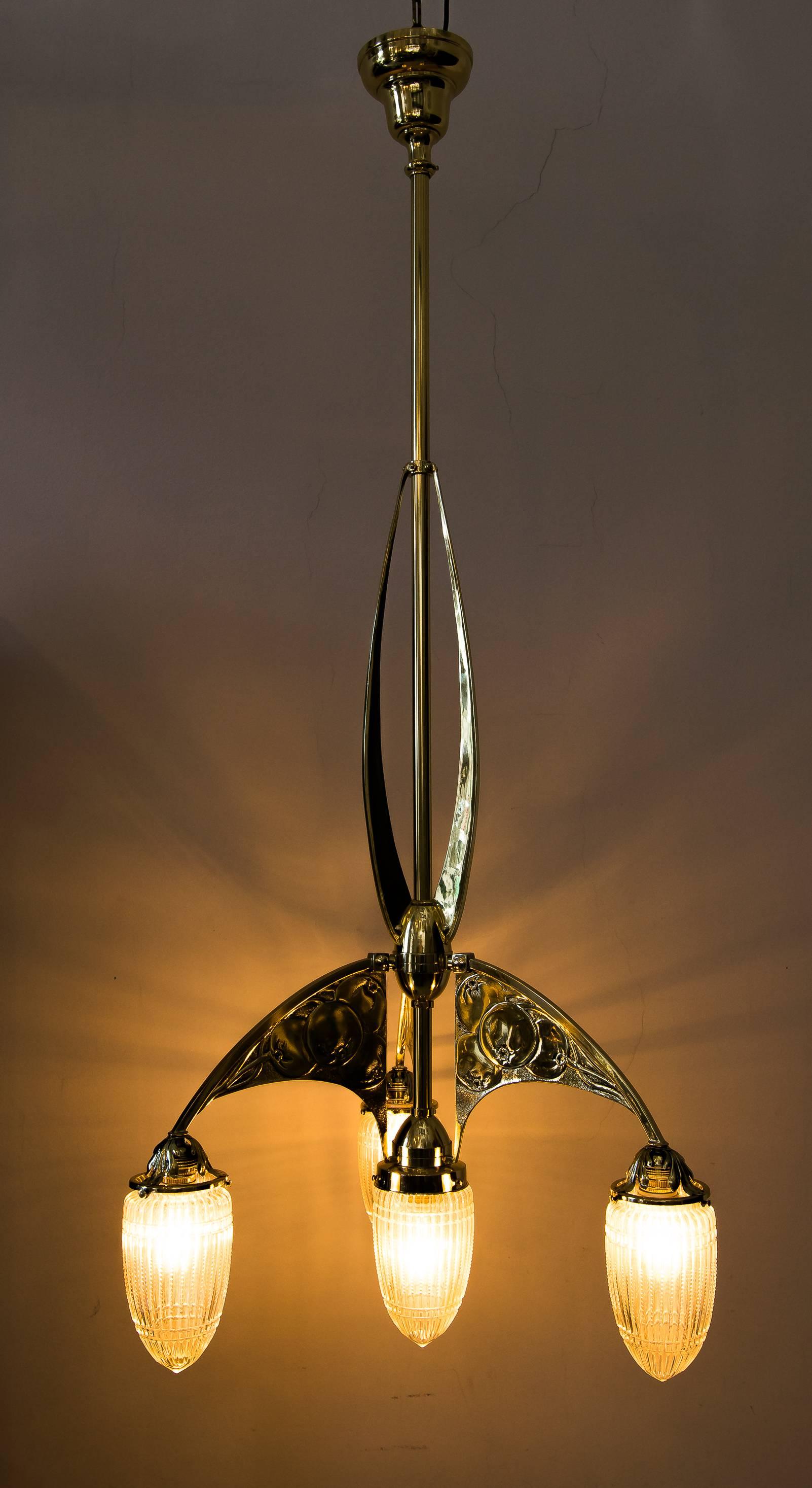 Beautiful Art Nouveau chandelier with original glass, circa 1908
Polished and stove enameled.
 