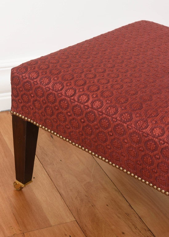 Classic pair of George S Smith tapered leg ottomans. 

Woven jacquard fabric, brass castered feet.