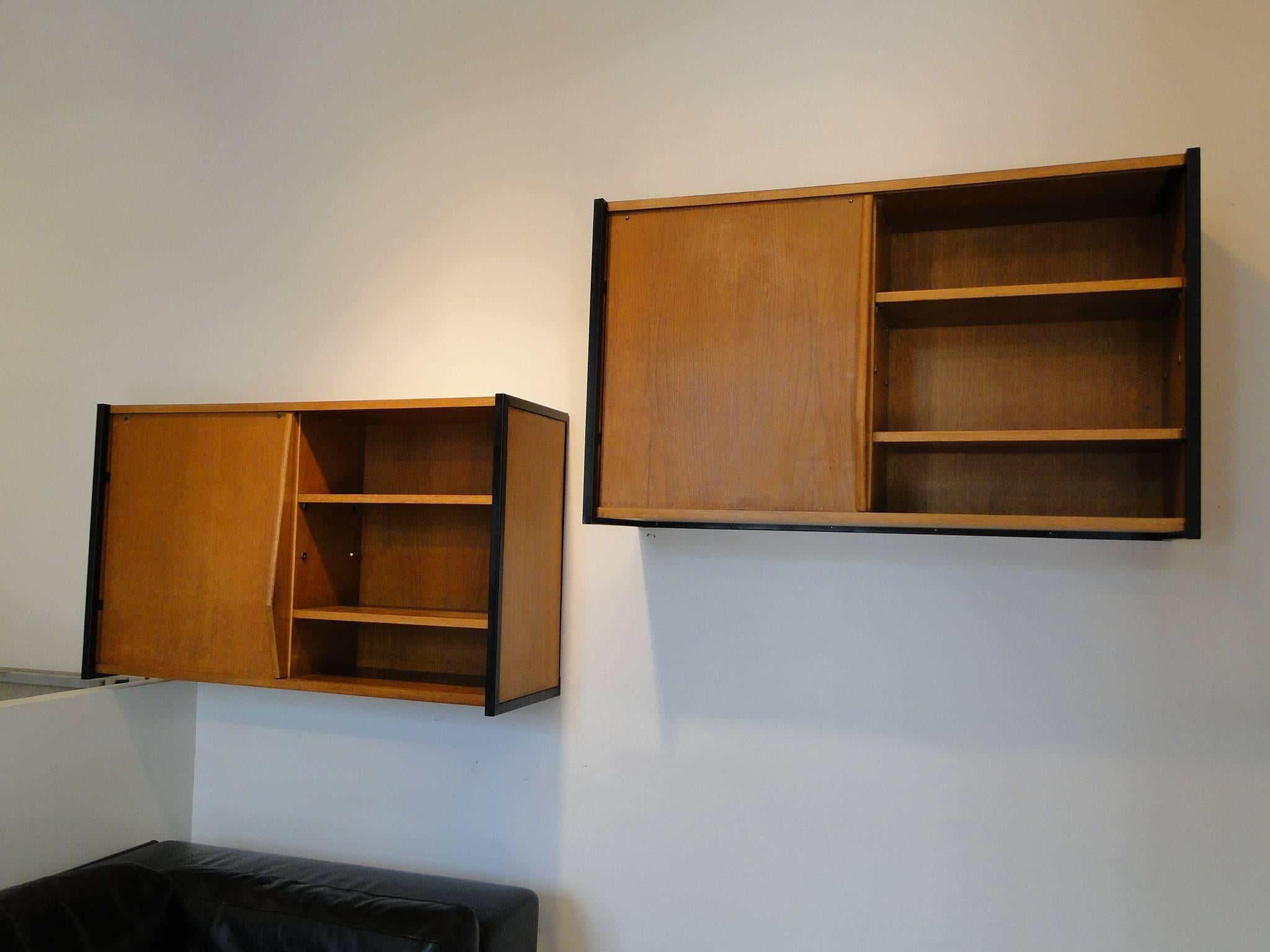 Available at the unit


Stunning wall-mounted Pair cabinets attributed to Charlotte Perriand, manufactured in France, circa 1950.

This beautiful pieces is made of the highest quality oakwood with black metal framing on the sides, giving it a