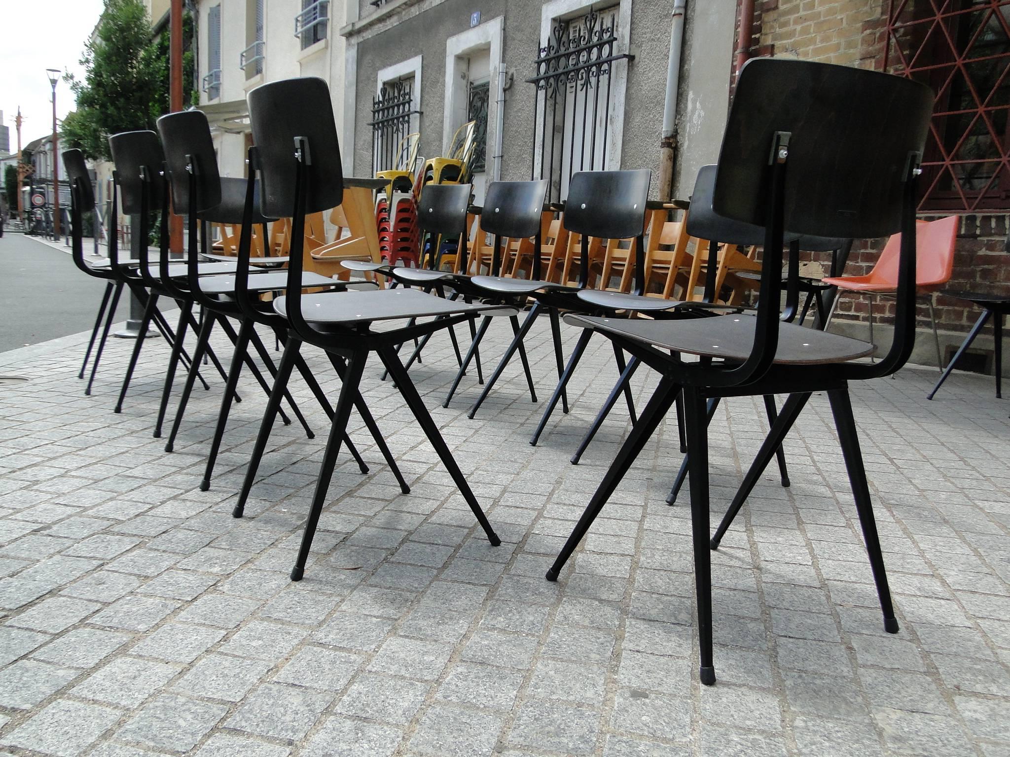 Large set of chairs model 'Result,' in plywood and metal, by Friso Kramer for Ahrend de Cirkel, the Netherlands, 1958. 

The frame is made of U-profiled sheet metal, coated in black. The seat and back are from laminated wood. The warm black color