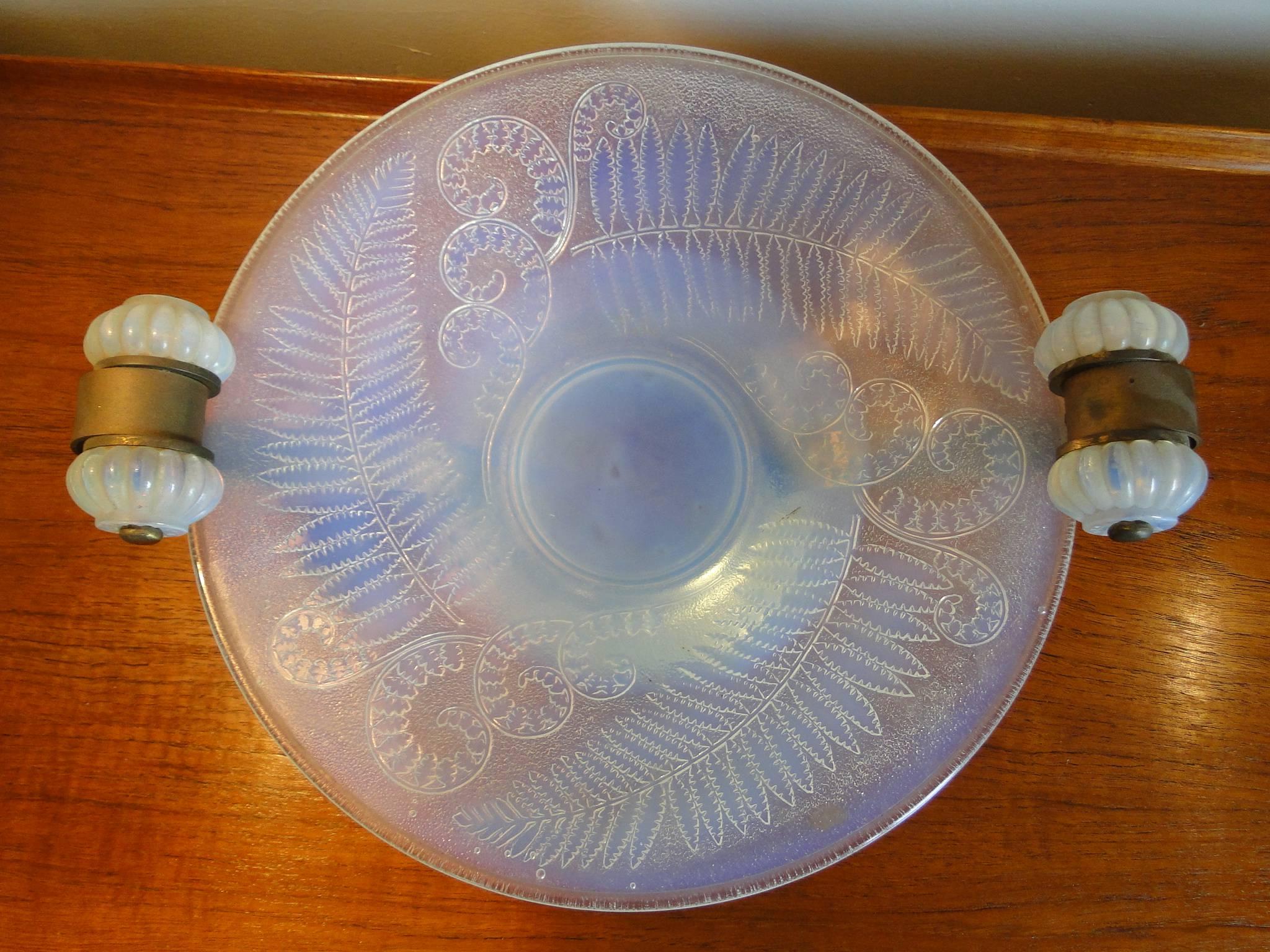 French Art Deco opalescent glass centerpiece bowl, Edmond Laurent Etling, France, circa 1930. Signed Etling France the centerpiece on round brass base with two large brass supports
 Perfect condition 
Diameter plate 35 cm 
Large whit the two arms