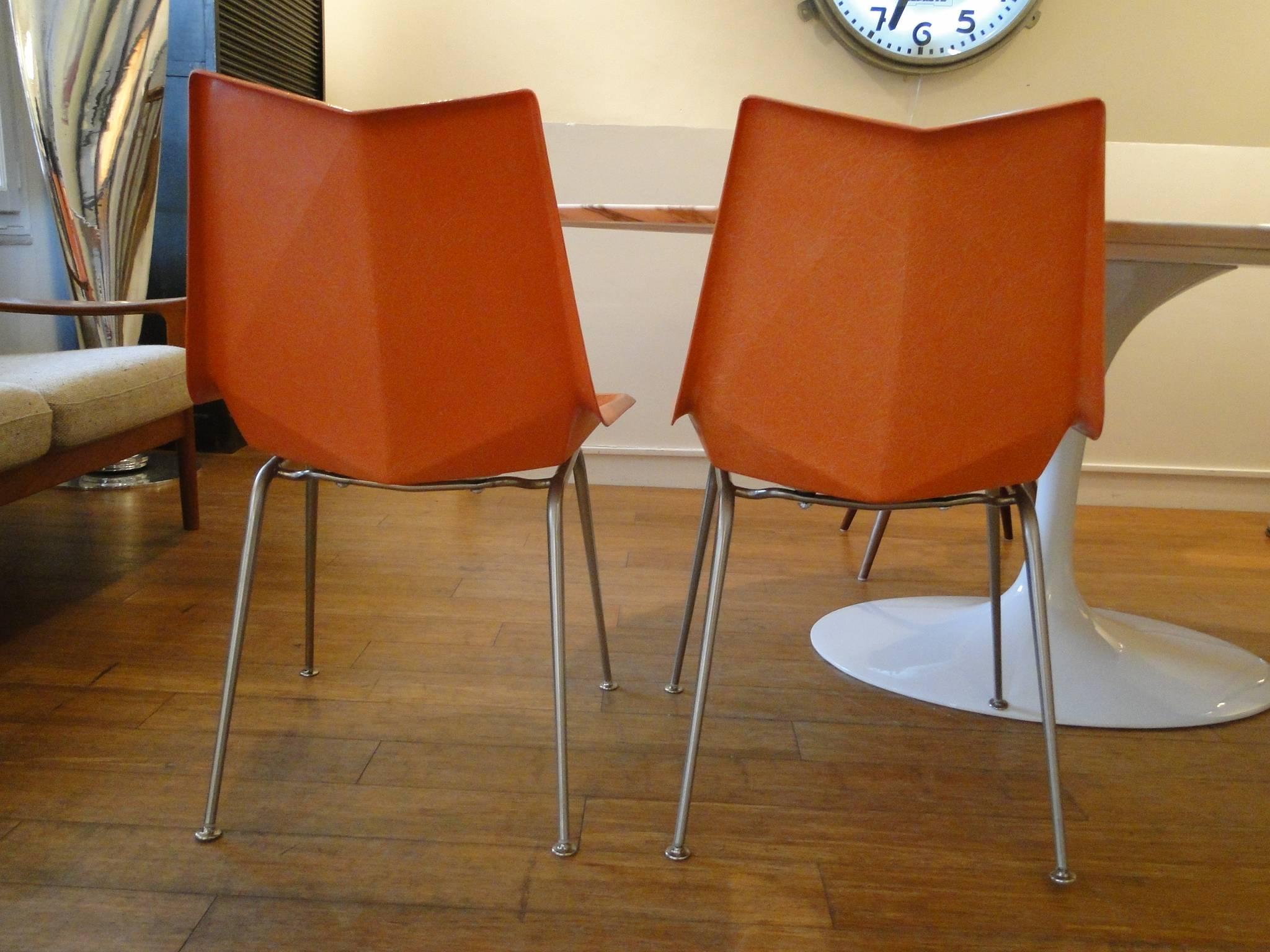 A rare design by Paul McCobb (American, 1917-1969) for St. John, circa 1950s, this all original Origami chairs if made of a orange fiberglass seat and chrome iron rod frame. The seat was molded at angles reminiscent of a Japanese origami. Still