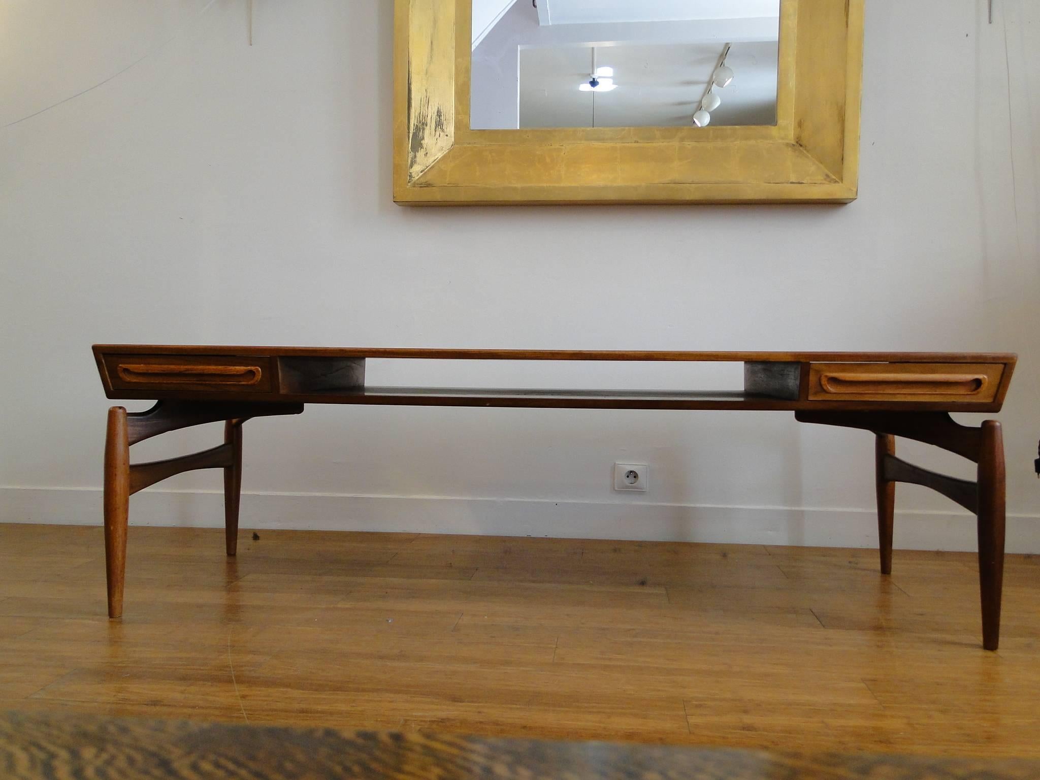 Vintage 1950s E.W. Bach coffee table

This Danish coffee table is a sculptural masterpieces. Shelves and drawers that open to both sides make the perfect coffee table. Ready for pick up, delivery, or shipping anywhere in the world.