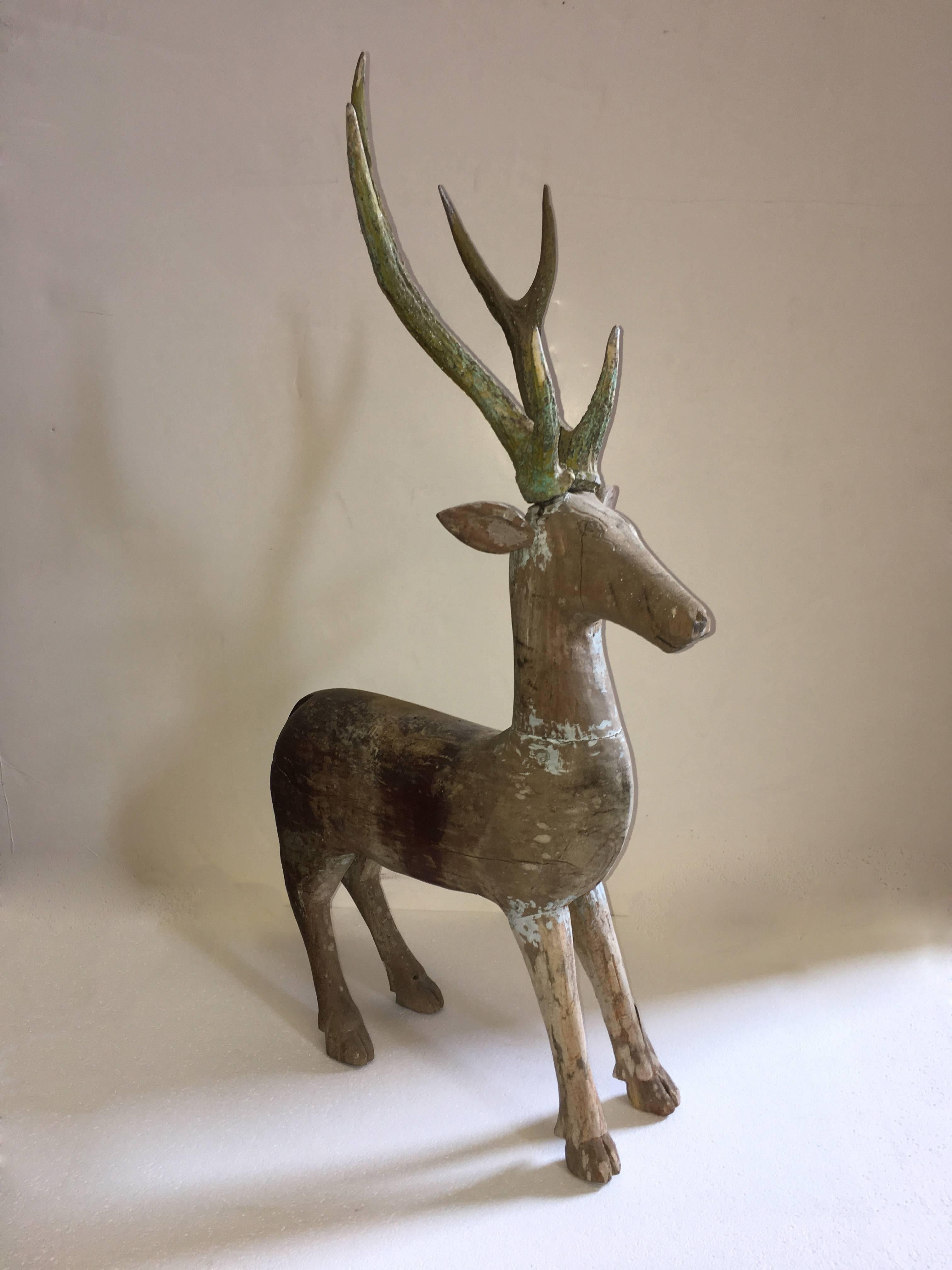 Old wooden deer, carved out of teak, from Java.