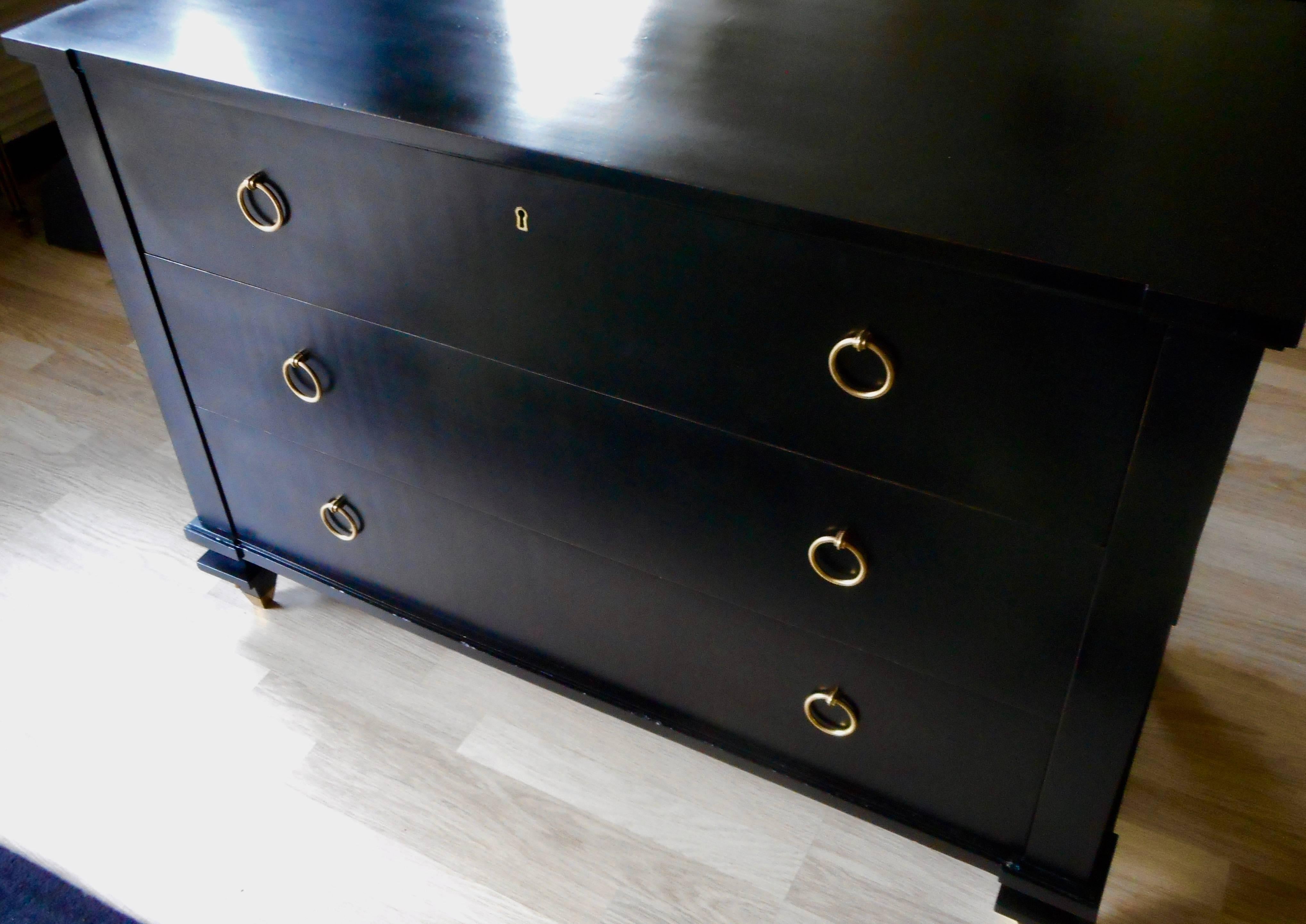 Ebonized, with bronze rings and sabots.
Three drawers, the top one is divided into eight compartments,
circa 1948.