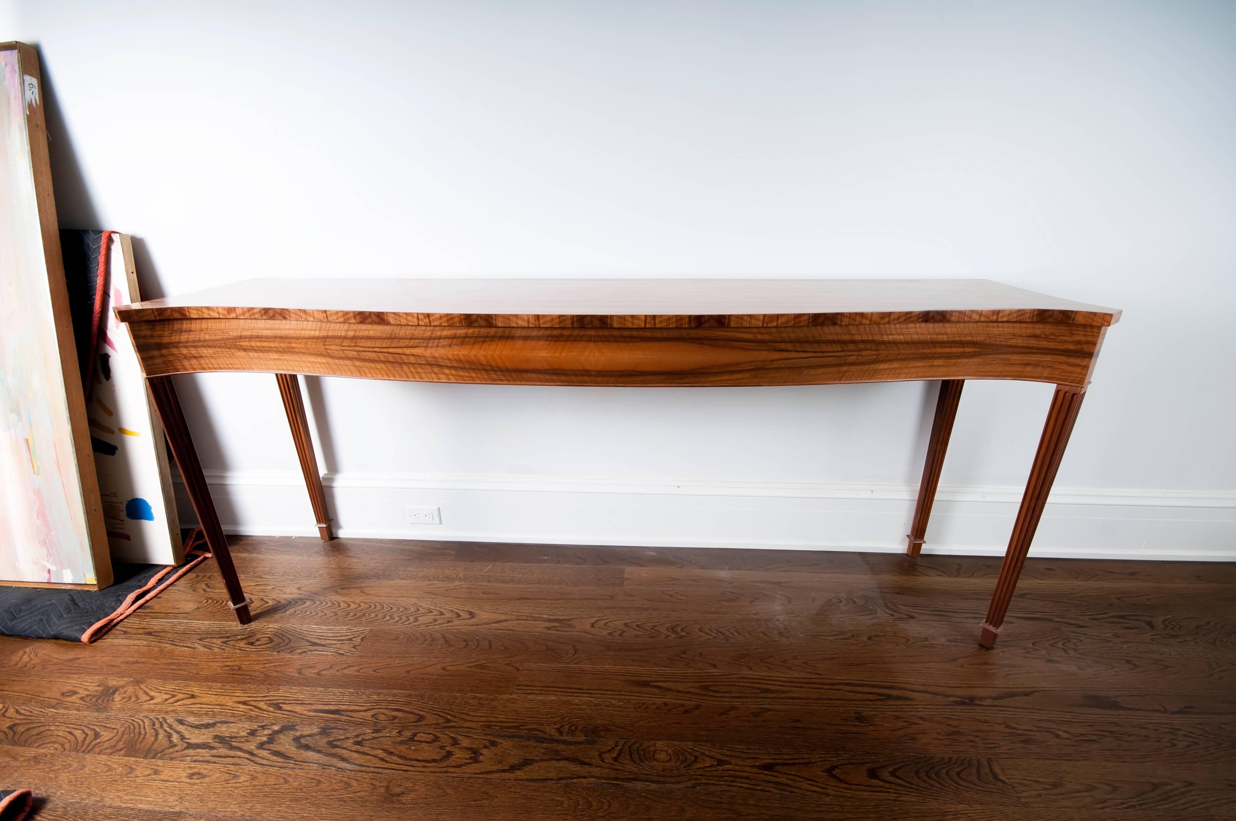 An exotic wood narrow console.