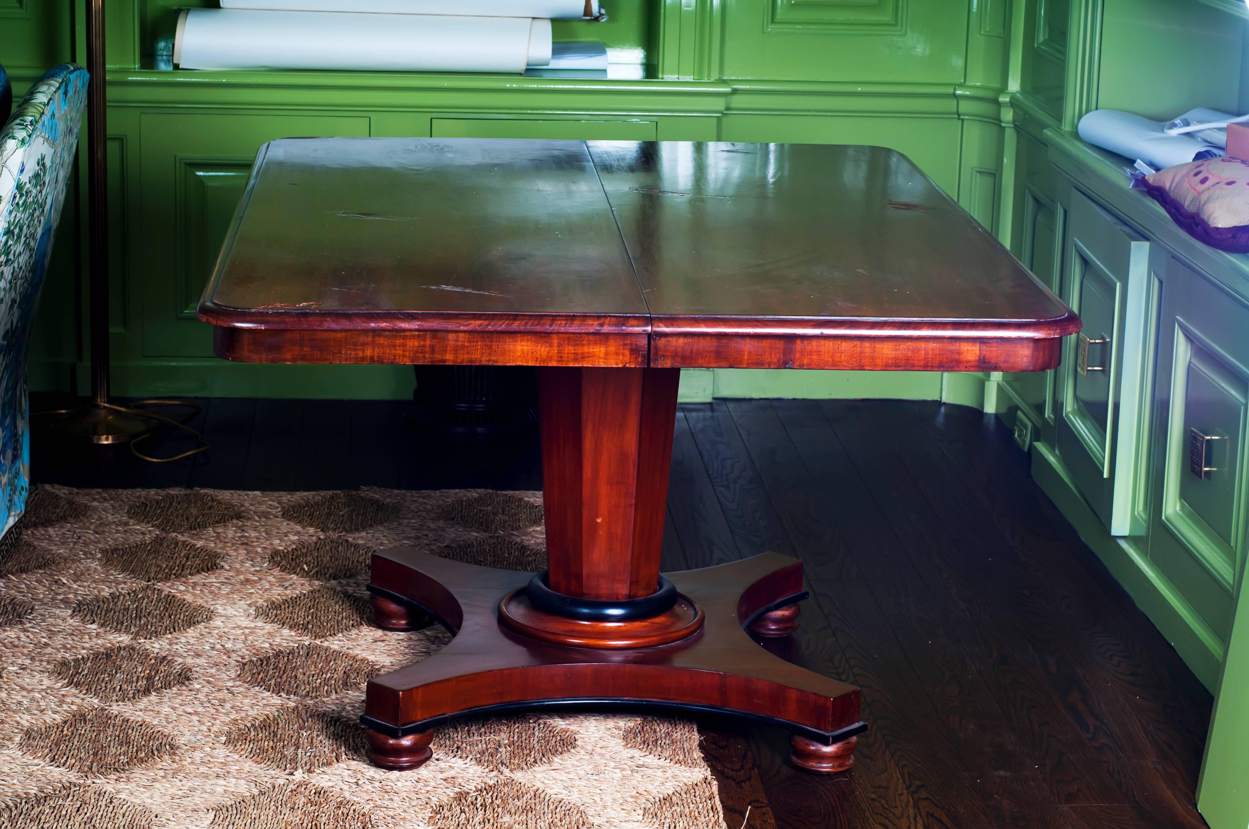 An antique Regency pedestal dining table with one leaf.

Leaf measures: 24