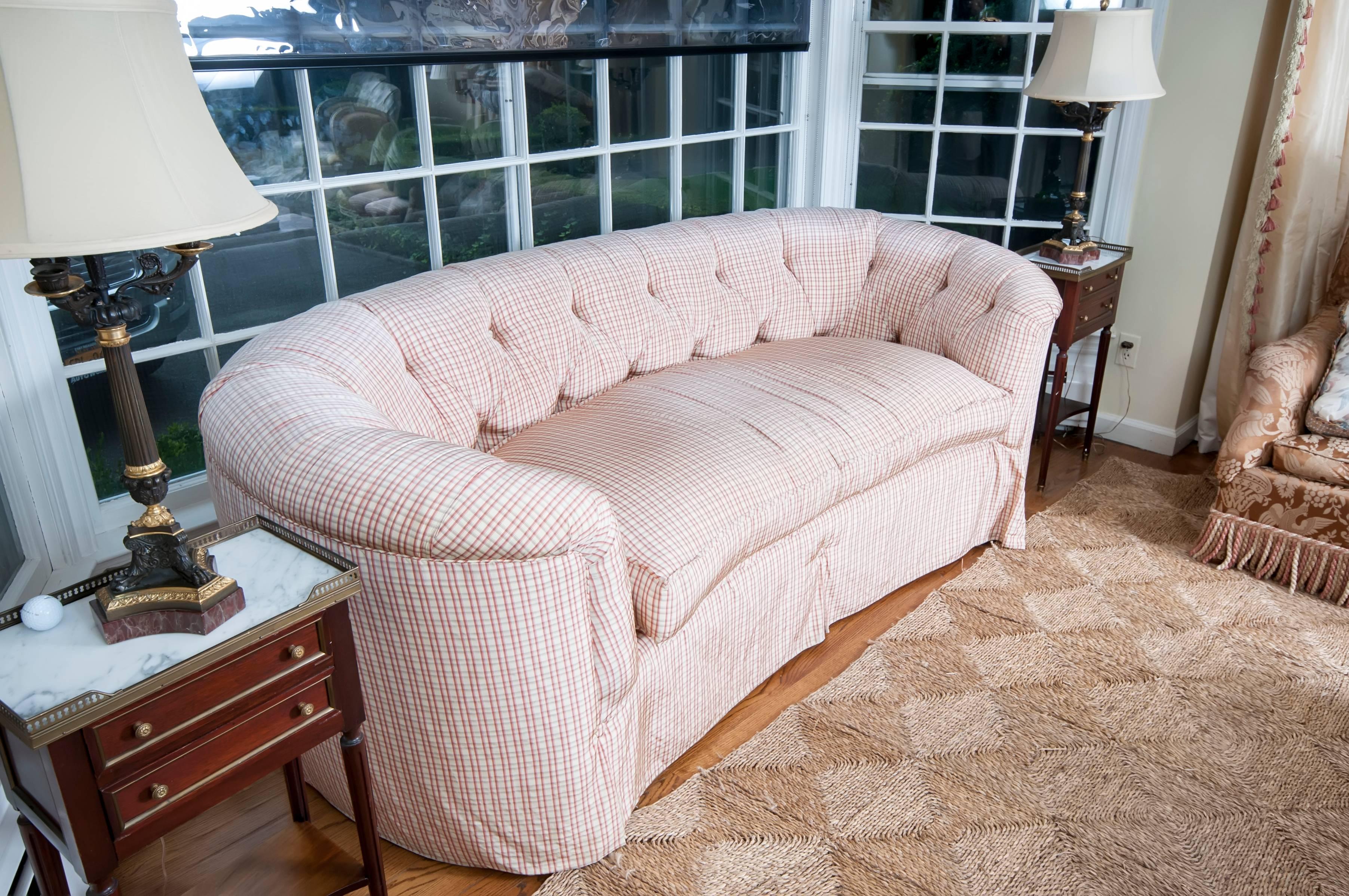 Palest pink curved tufted love seat upholstered in Brunschwig and Fils silk check.