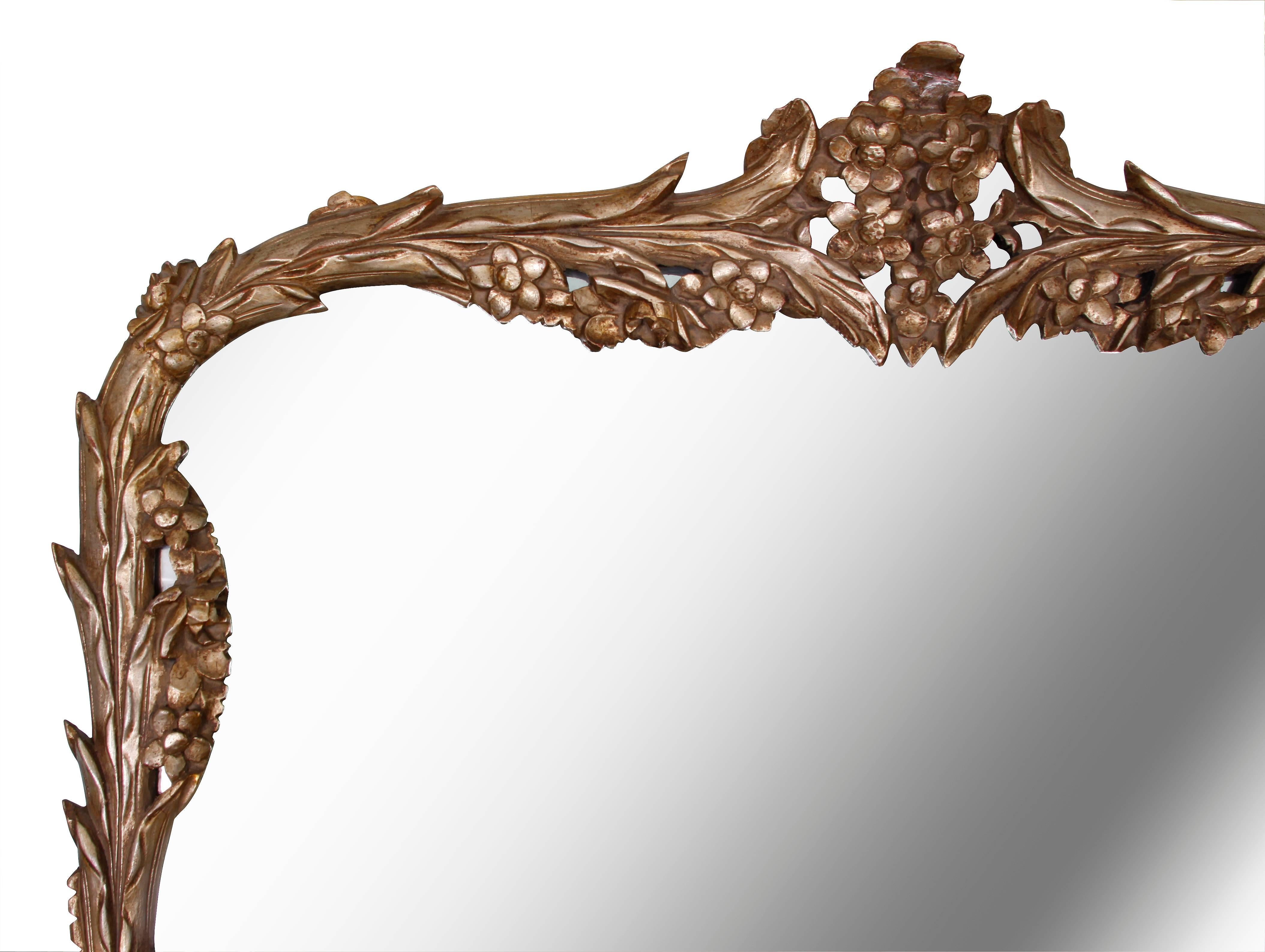 Neoclassical silvered Acanthus leaf and petal foliate mirror. Delicately detailed in a deep silver gilt finish. 