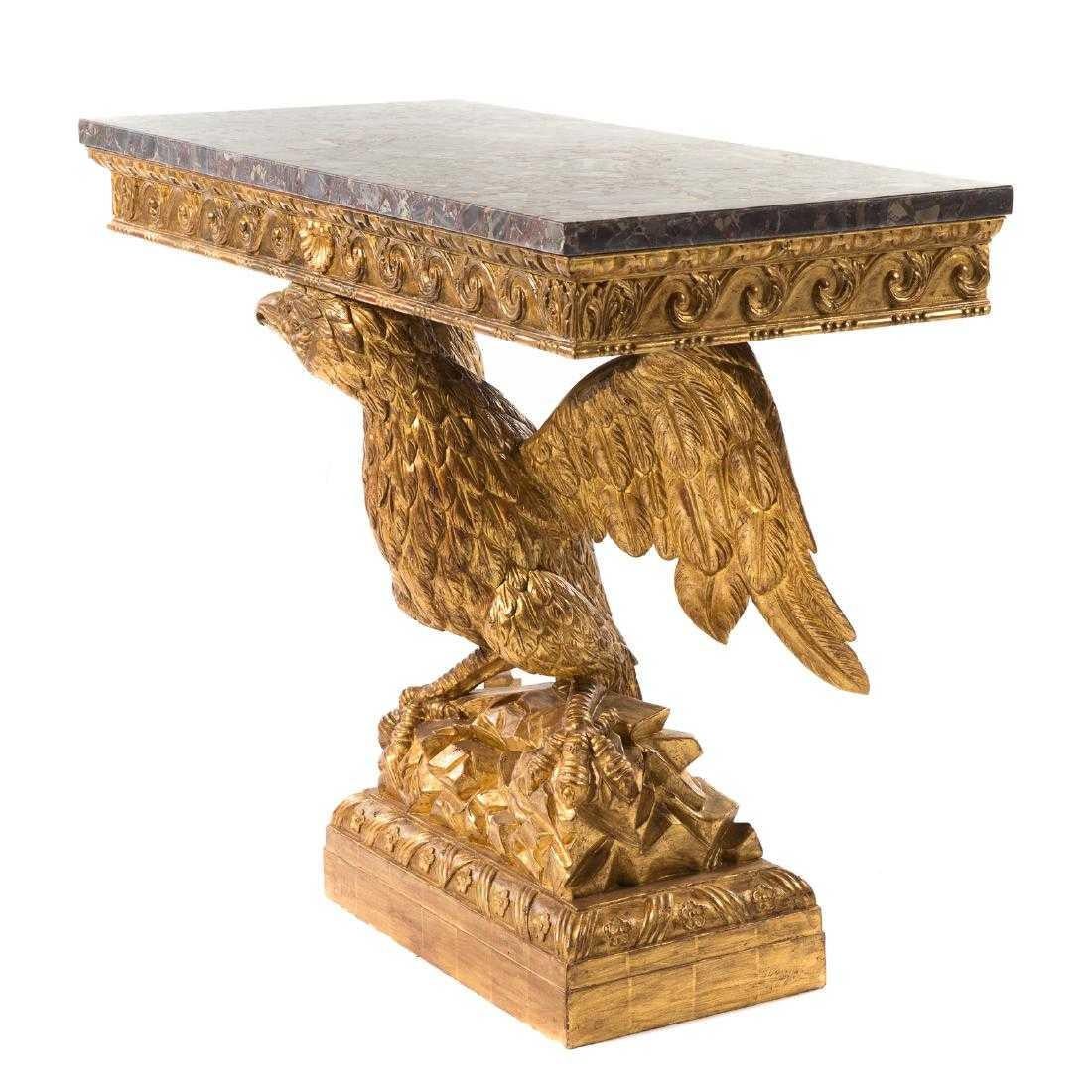 George II style carved giltwood eagle console n the manner of William Kent, 20th century; rectangular grey breccia marble top, scroll carved apron, carved winged eagle standards on rusticated base, carved plinth base.