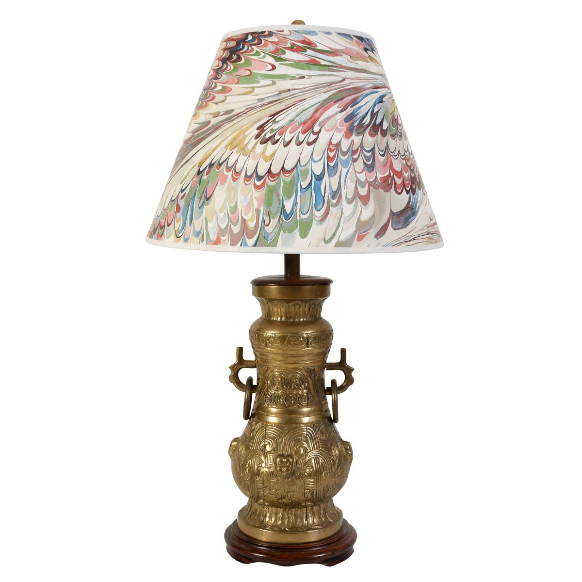 Elegant and richly detailed, this pair of bronze urn-shaped table lamps brings a touch of Chinoiserie sophistication to any interior. The lamps feature ornate raised detailing inspired by traditional Asian motifs, showcasing intricate patterns and