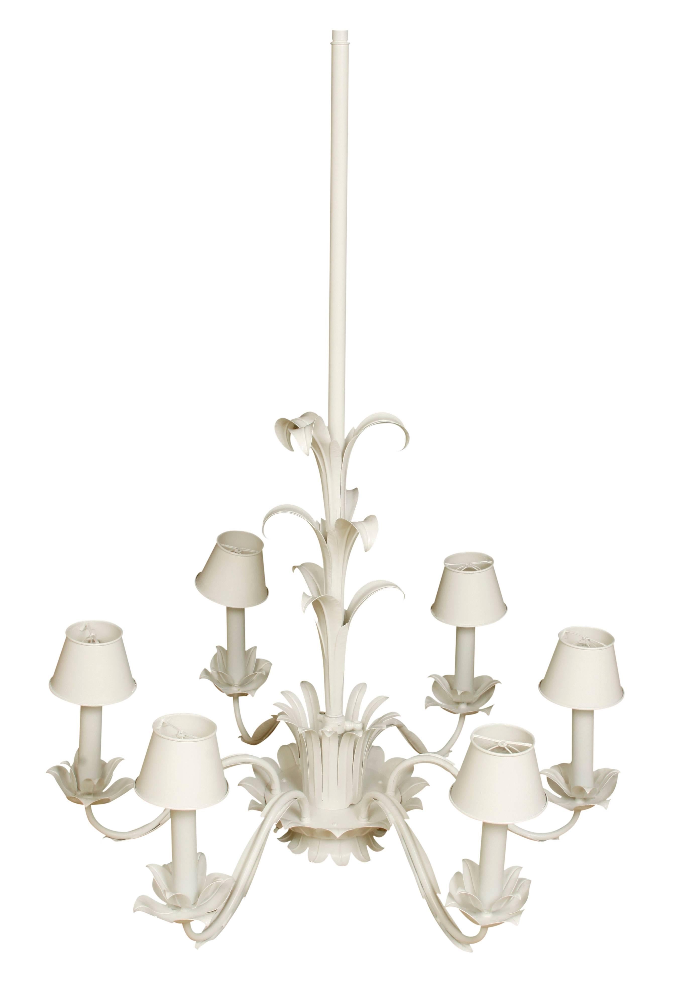 A six-arm sculpted metal lotus style chandeliers with matching metal shades.