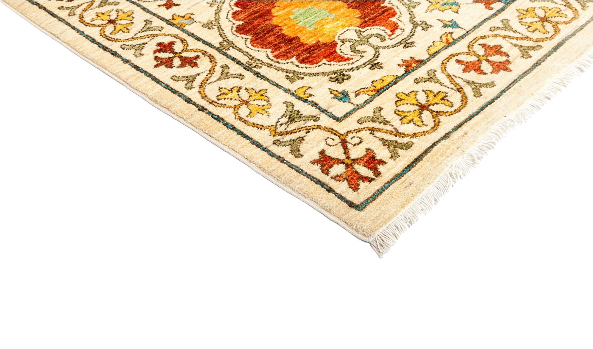Inspired by embroidered Suzani textiles from Uzbekistan, this rug features floral motifs in modern palettes and compositions. Hand-knotted of vegetable-dyed wool, the rugs are designed to retain their vibrancy for generations to come. Measure: 9' x