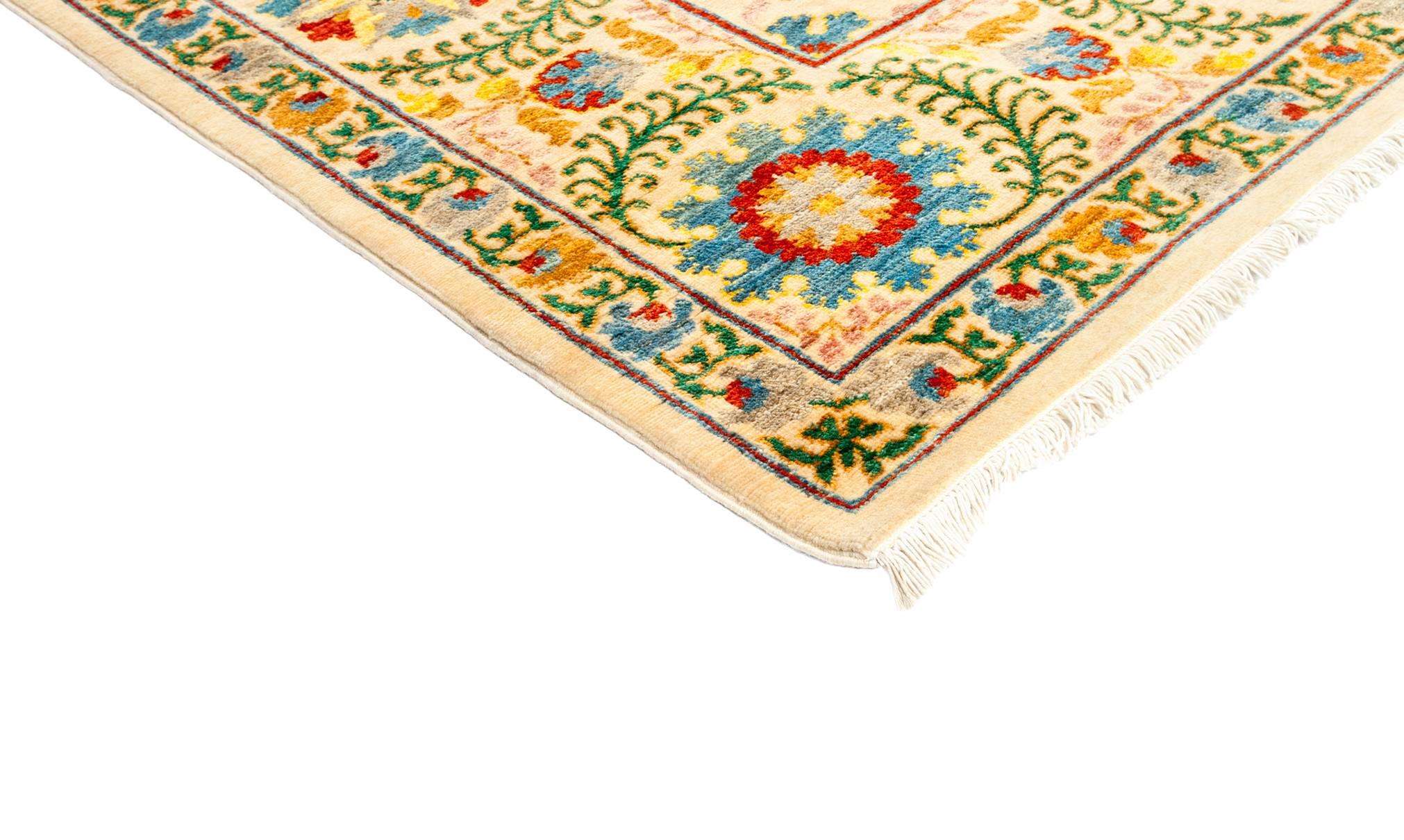 Inspired by embroidered Suzani textiles from Uzbekistan, this rug features floral motifs in modern palettes and compositions. Hand-knotted of vegetable-dyed wool, the rugs are designed to retain their vibrancy for generations to come. Measures: 8'3