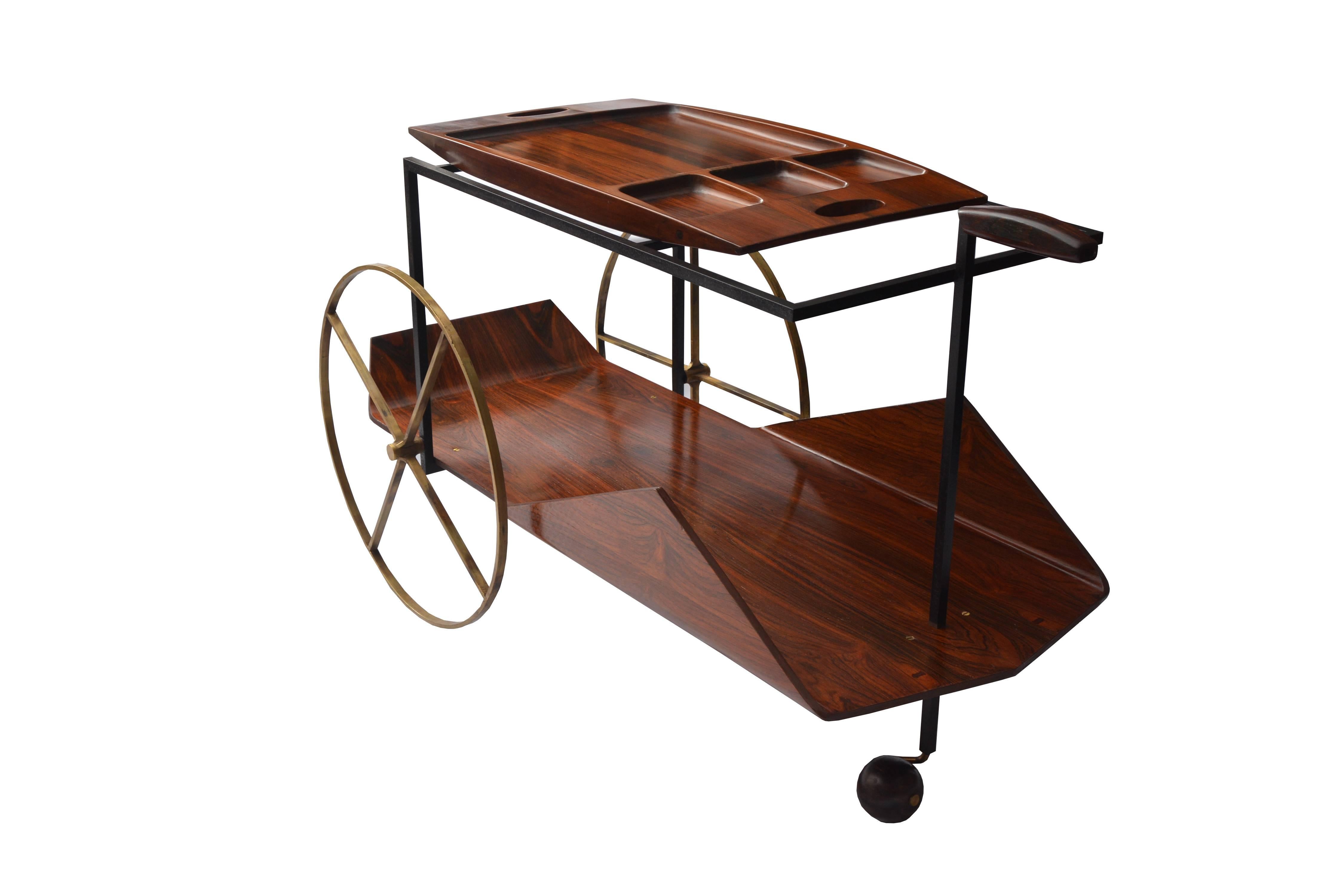 Jorge Zalszupin’s exquisite 1950s tea trolley, bar, made in Brazilian jacaranda with brass wheels and ball foot. The top shelf is a removable tray.