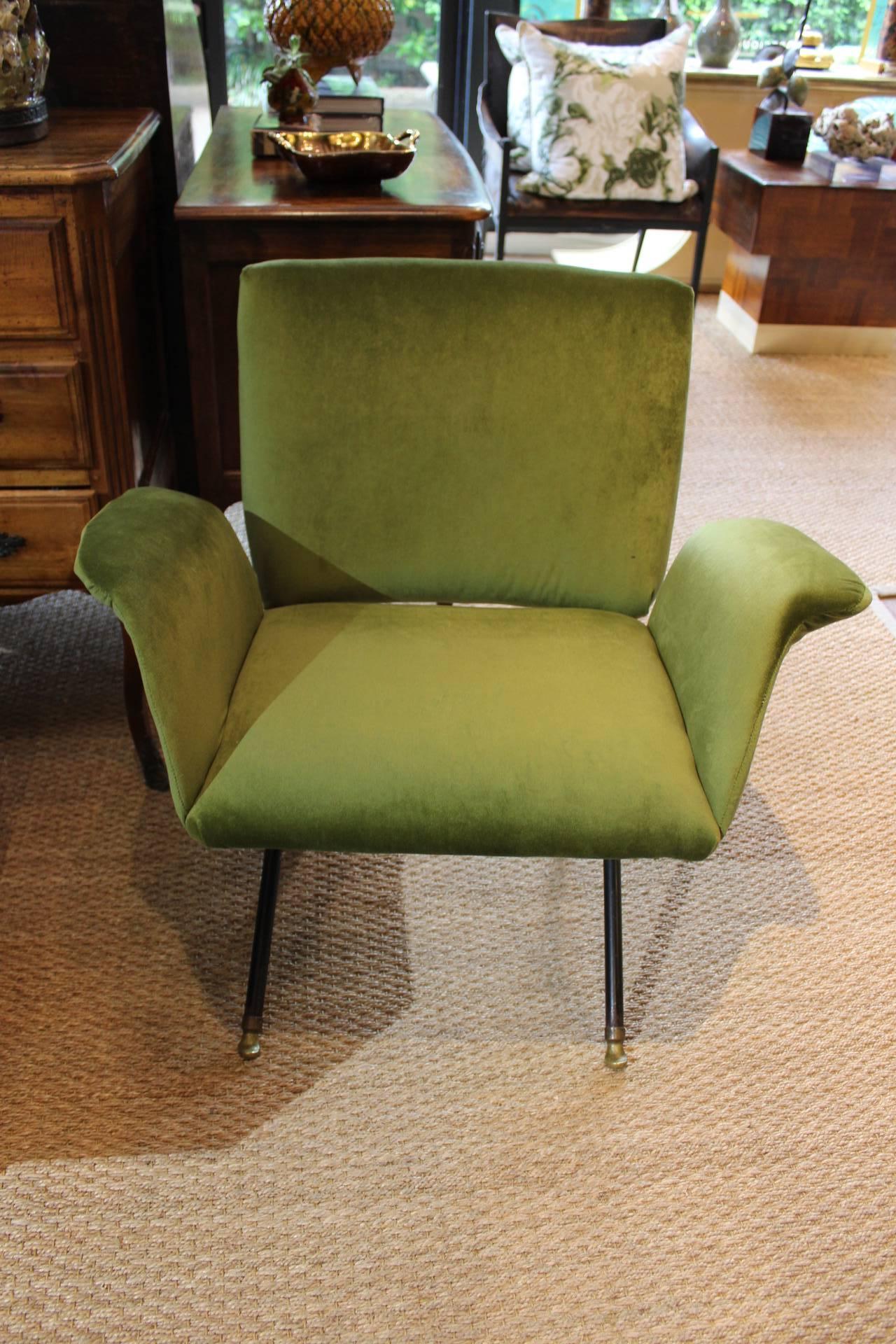 Pair of moss green velvet armchairs with iron cross base and two adjustable lounge settings with brass capped feet at base. Designed in the manner of Jules Leleu.