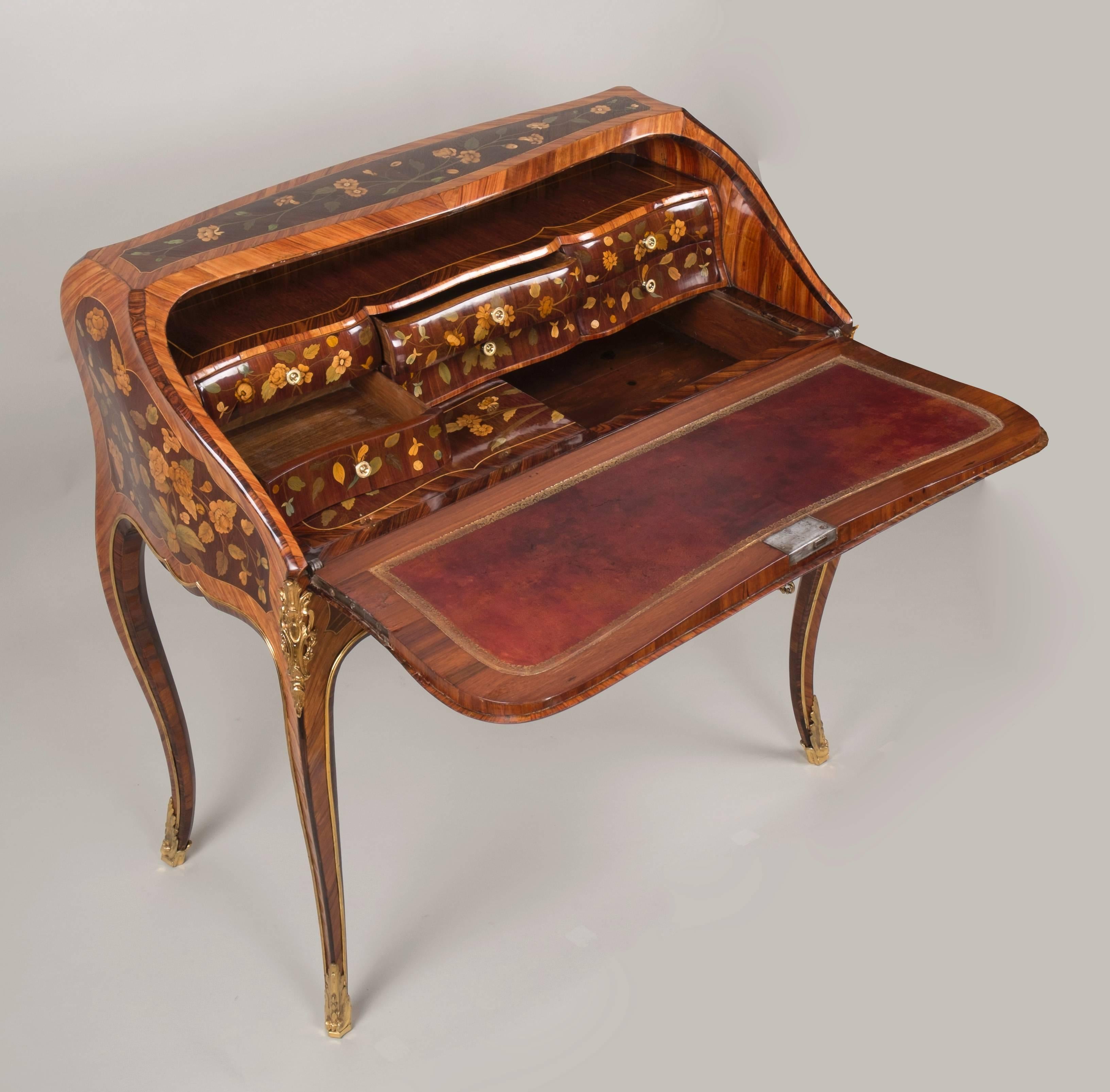 Louis XV "Dos d'ane" desk inlaid with amaranth and tulipwood, floral marquetry and attributes of music, curved faces.

Its interior has six curved drawers and a false bottom which are decorated with a floral marquetry.

Work from Louis