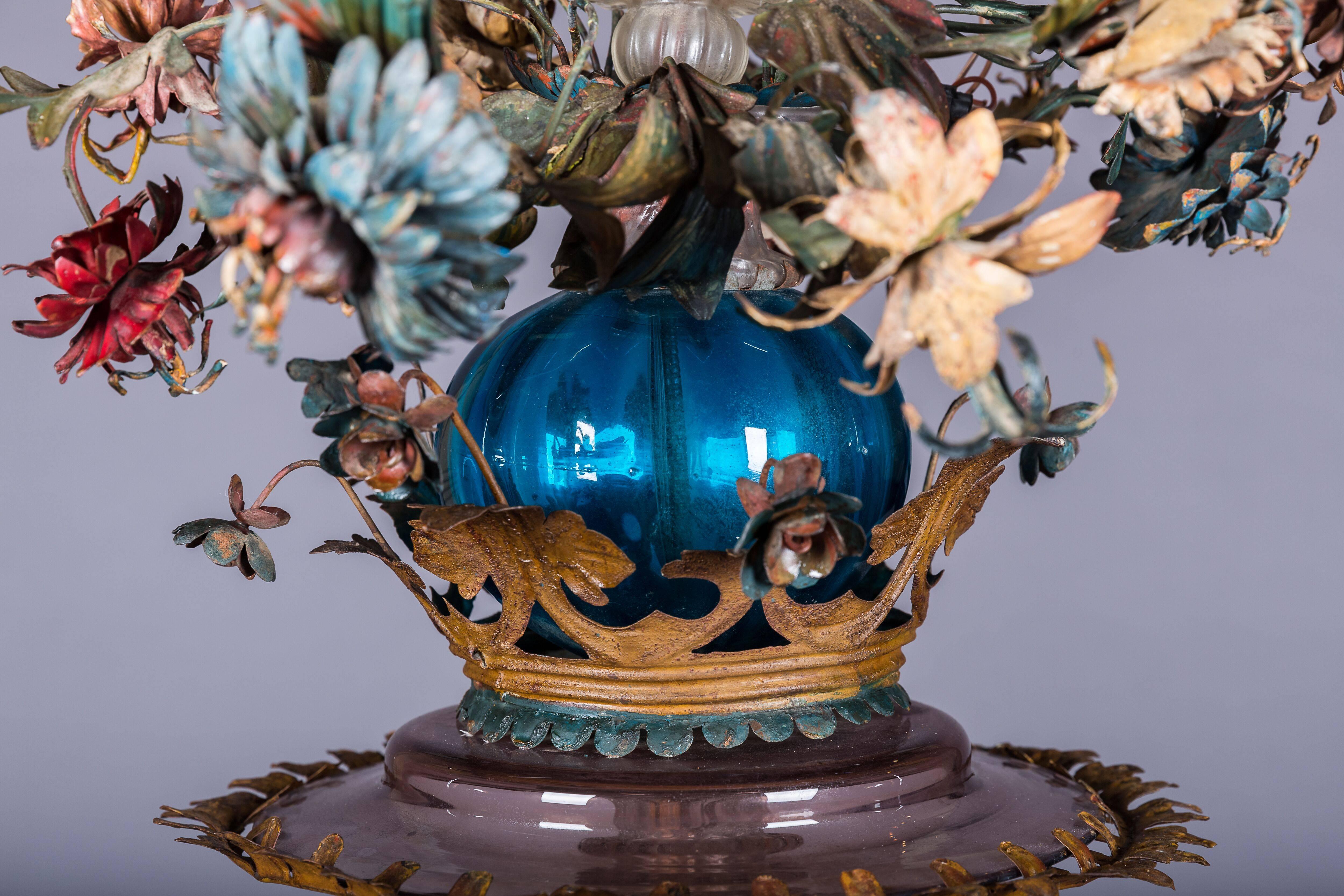 Lantern with eighteen lights made of cut and pushed away iron decorated with flowers and leafs.
Work from the 18th century, probably from Piedmont.
Historically, Turkey seems to be the birthplace of painted sheet metal with objects like tea pot or