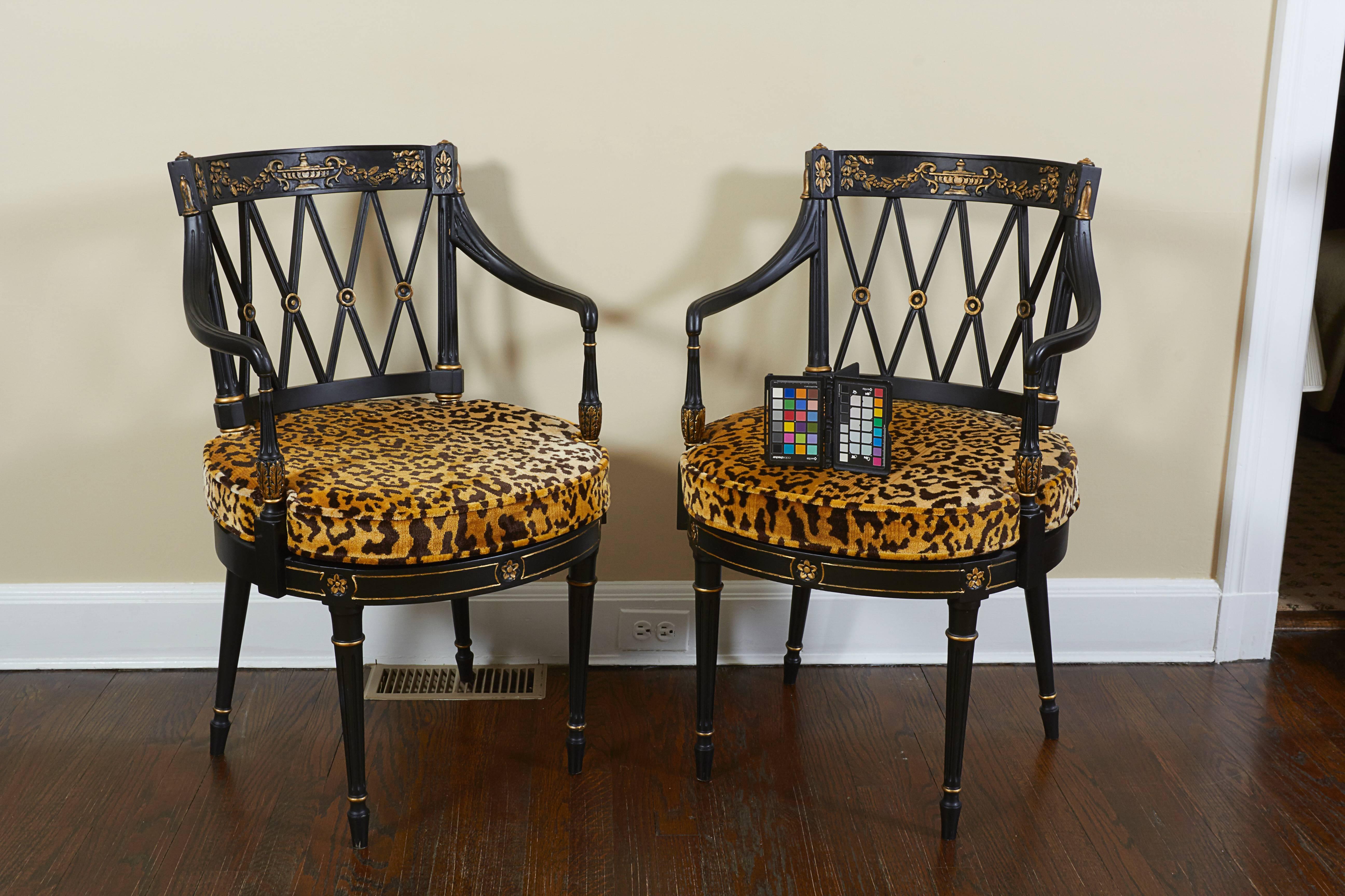 Each with square back with crest rail centered by a Classical urn festooned with garlands over a diamond trellis back; the loose leopard velvet cushion over a seat rail carved with gilt flowerheads raised on turned tapering legs.