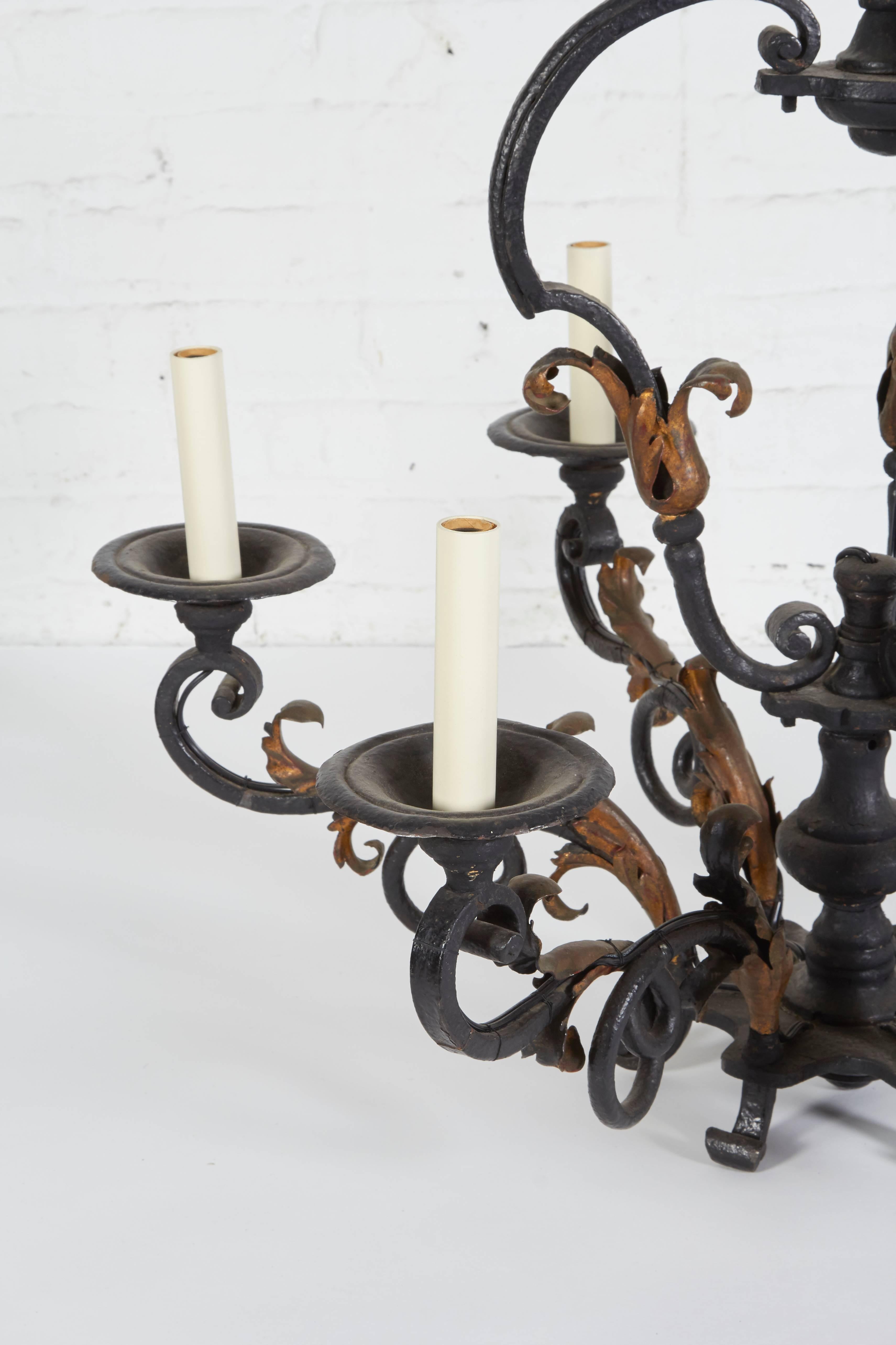 Featuring six outscrolled candle arms with gilt foliate detailing. Has been UL wired for electricity.