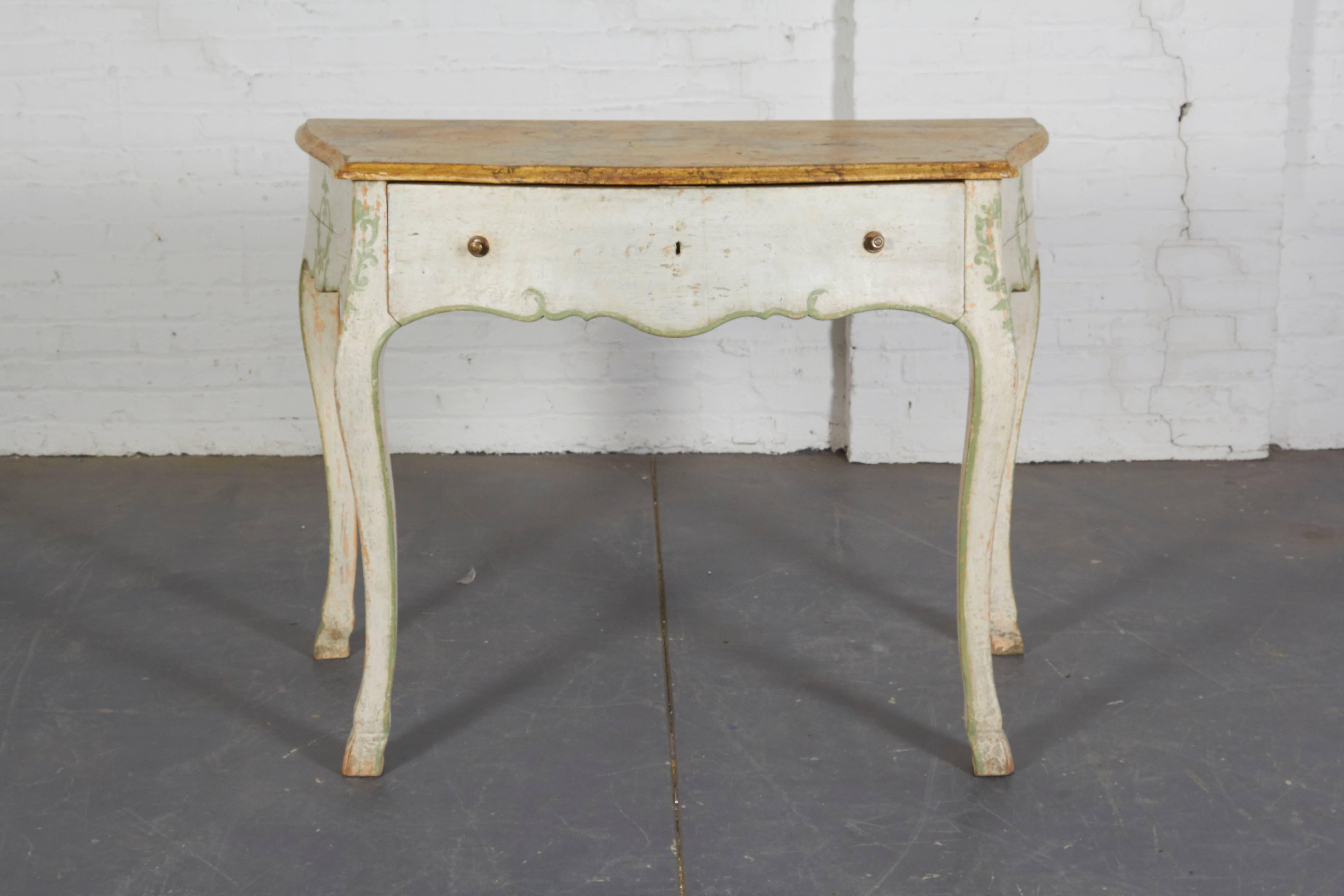 Each with faux marble top of bombe form over a frieze drawer raised on cabriole legs ending in hoof-form feet. Painted in a chalky white with celadon green cartouche decoration and banding. Impressively scaled.