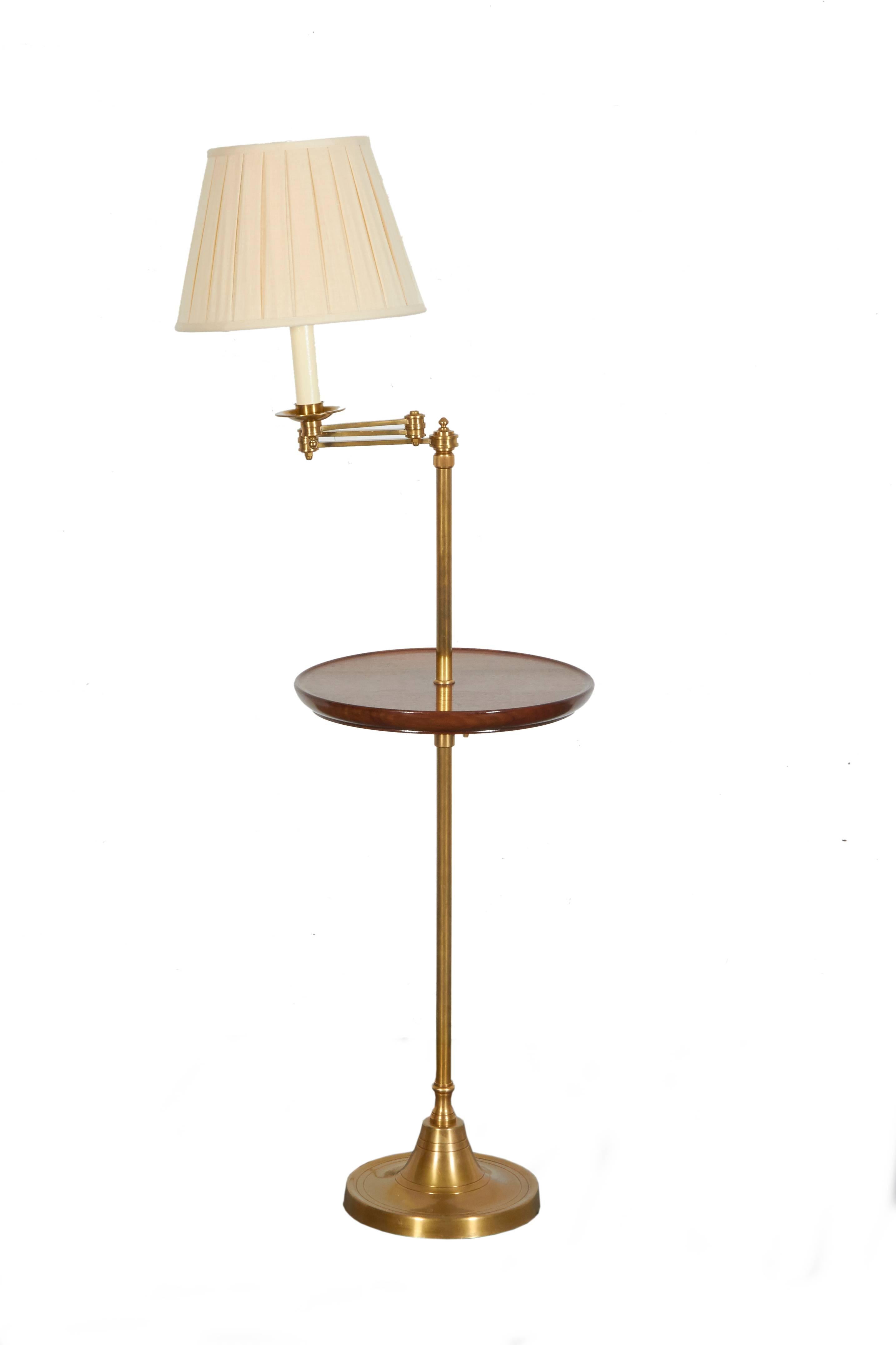 Each with brass adjustable columnar support with round mahogany tabletop that also can be adjusted to the desired height. With custom box-pleated lampshade by Abat Jour. Can adjust from 50