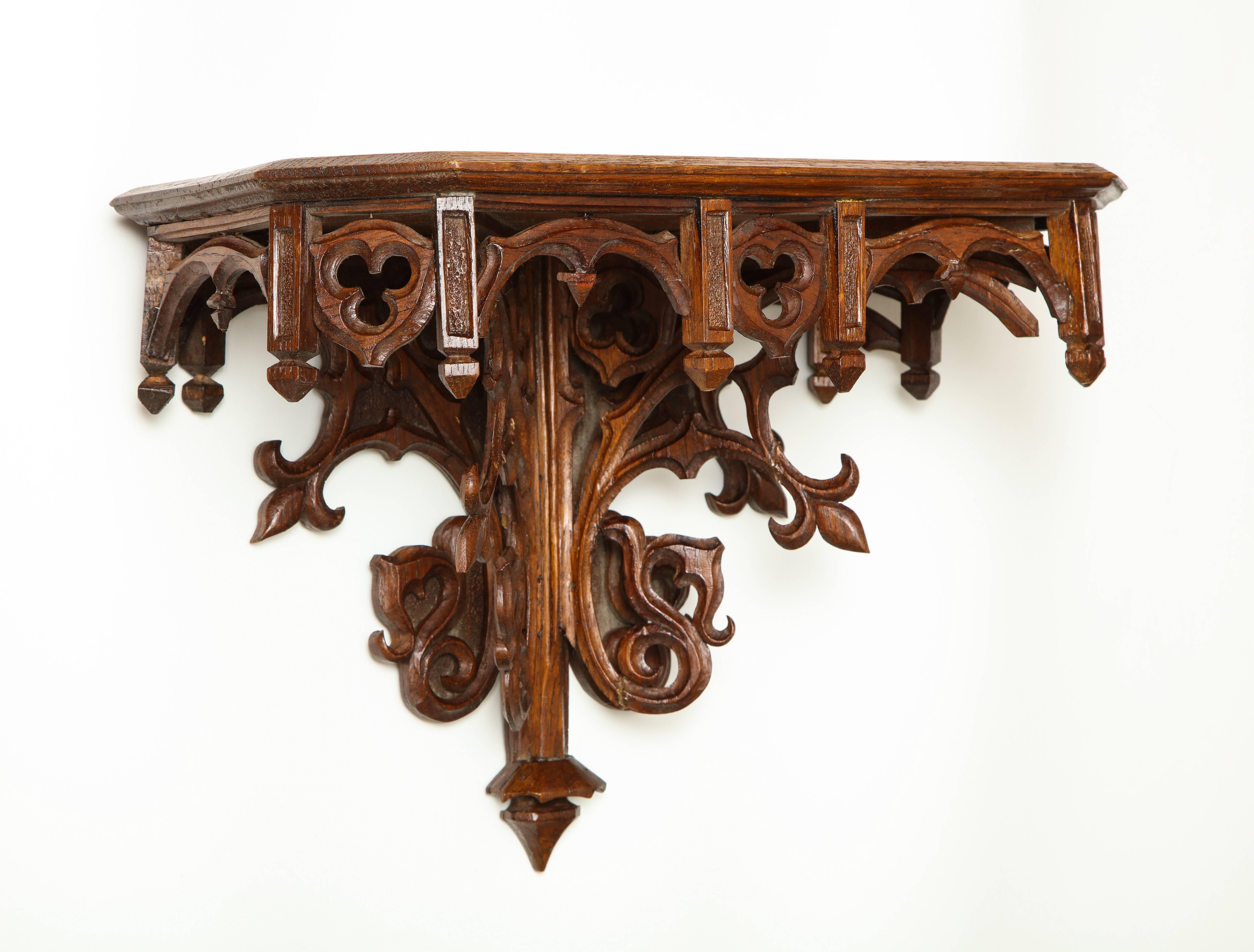 The oak has deepened to a pleasing color; finely carved with tracery decoration.
