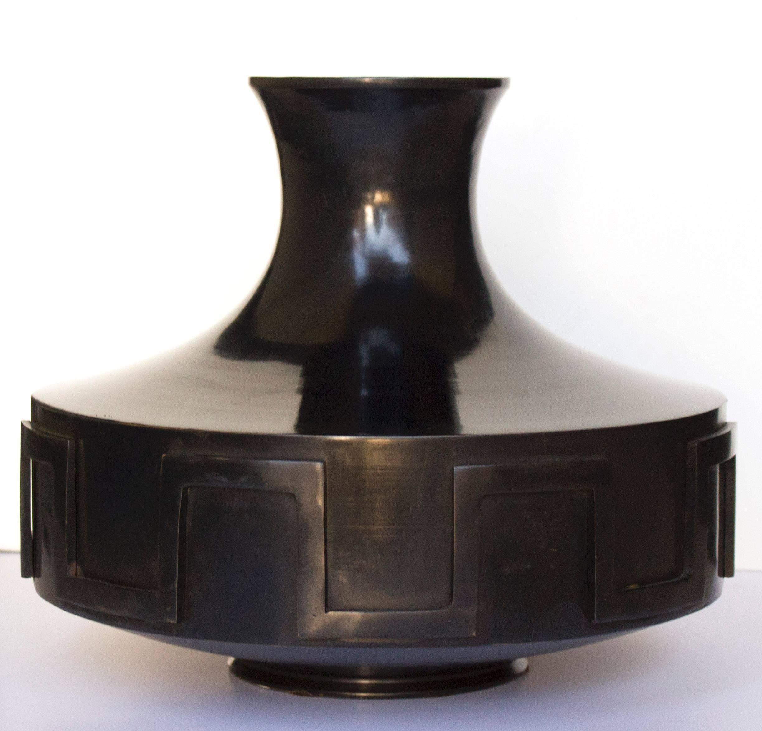 A Grecian style urn in dark bronze by Thomas Pheasant.