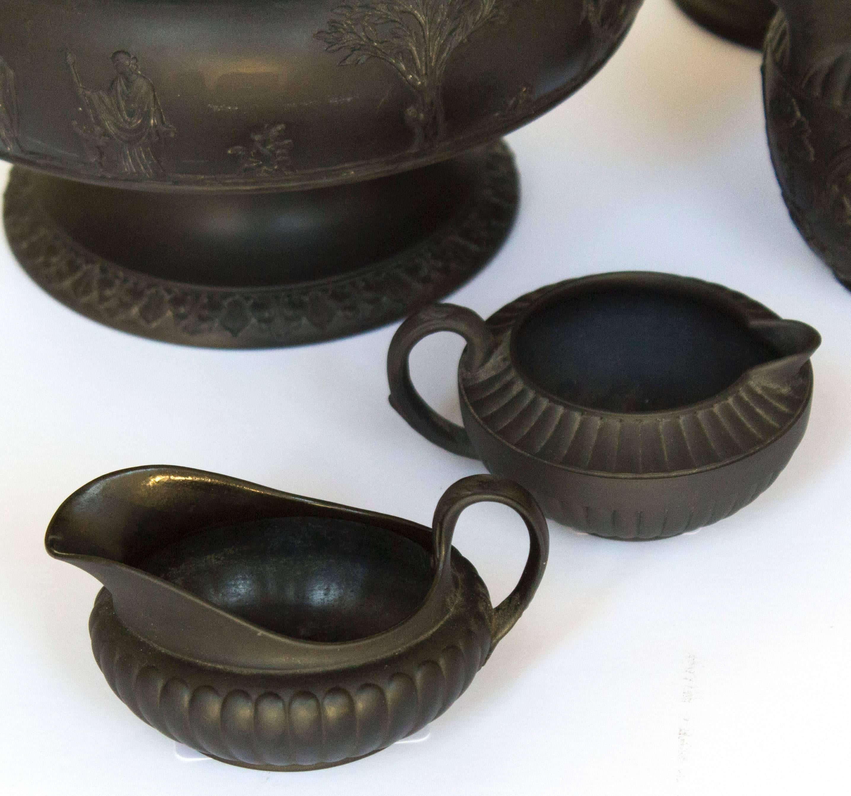 A five-piece set of Wedgwood Jasperware in black basalt. Tallest piece is approximately 12.5