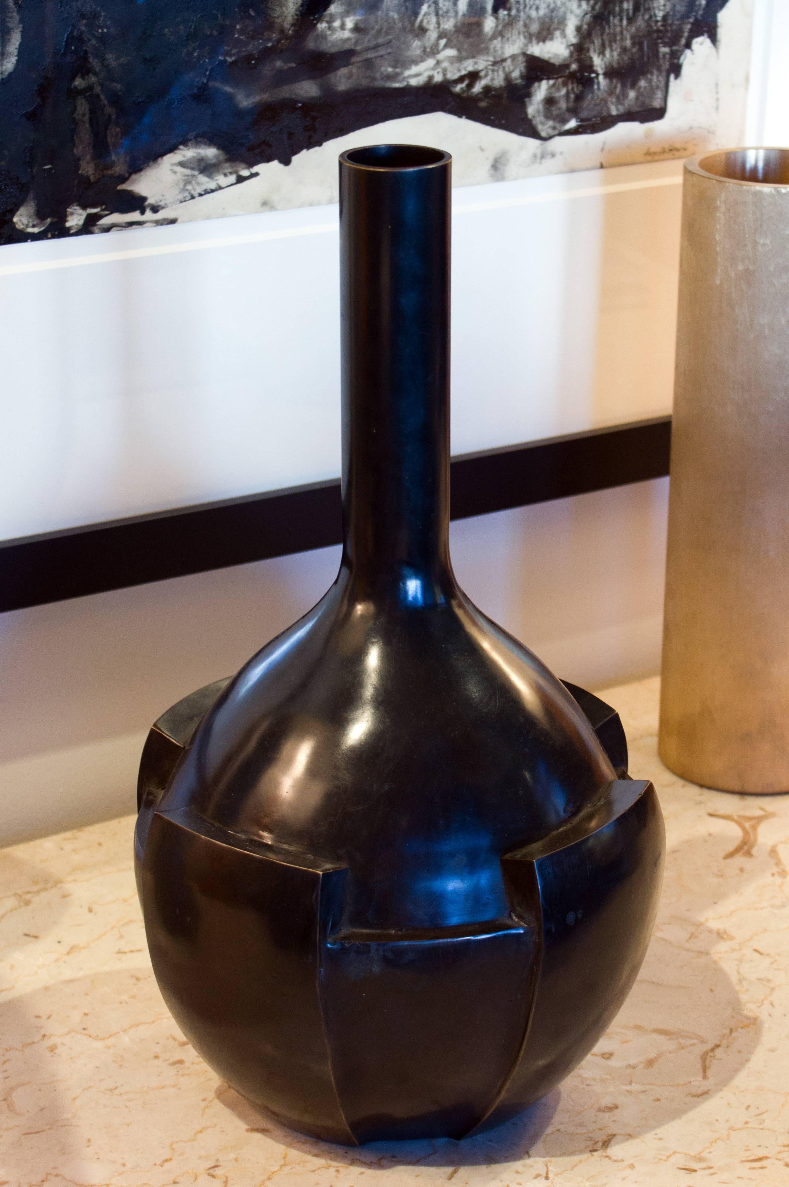 This stylized form is a modern take on the 1940s Art Deco designs. The Thomas Pheasant Petal Vase is updated with angular lines and squared edges. Dark bronze.
