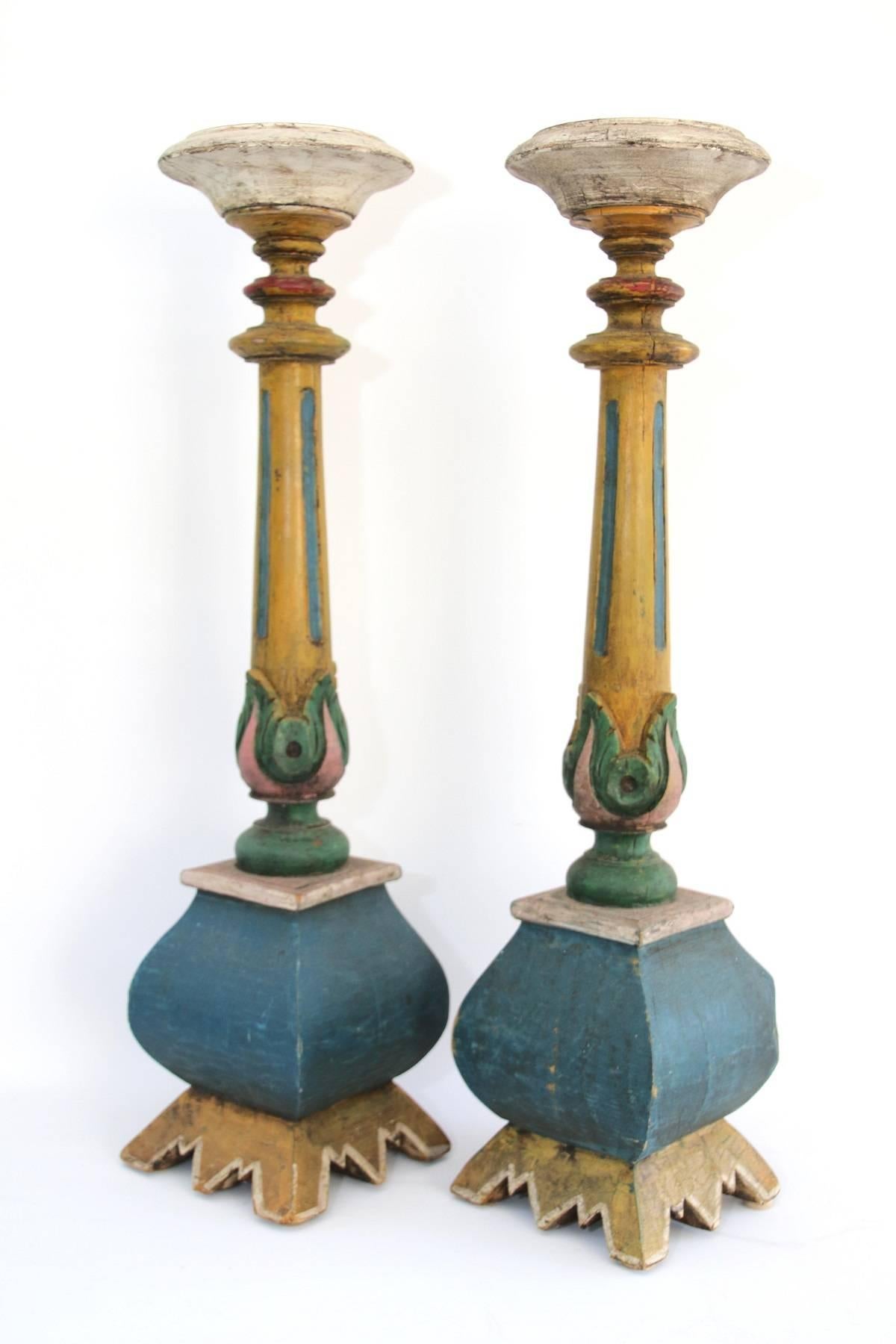 Pair of 19th century American polychrome paint decorated candle pillars with floral decoration. Hand-carved pine with original multi-color paint decoration.

Drying crack on one side of each pillar as shown in photos.

Measure: 25 ¾” high.
 