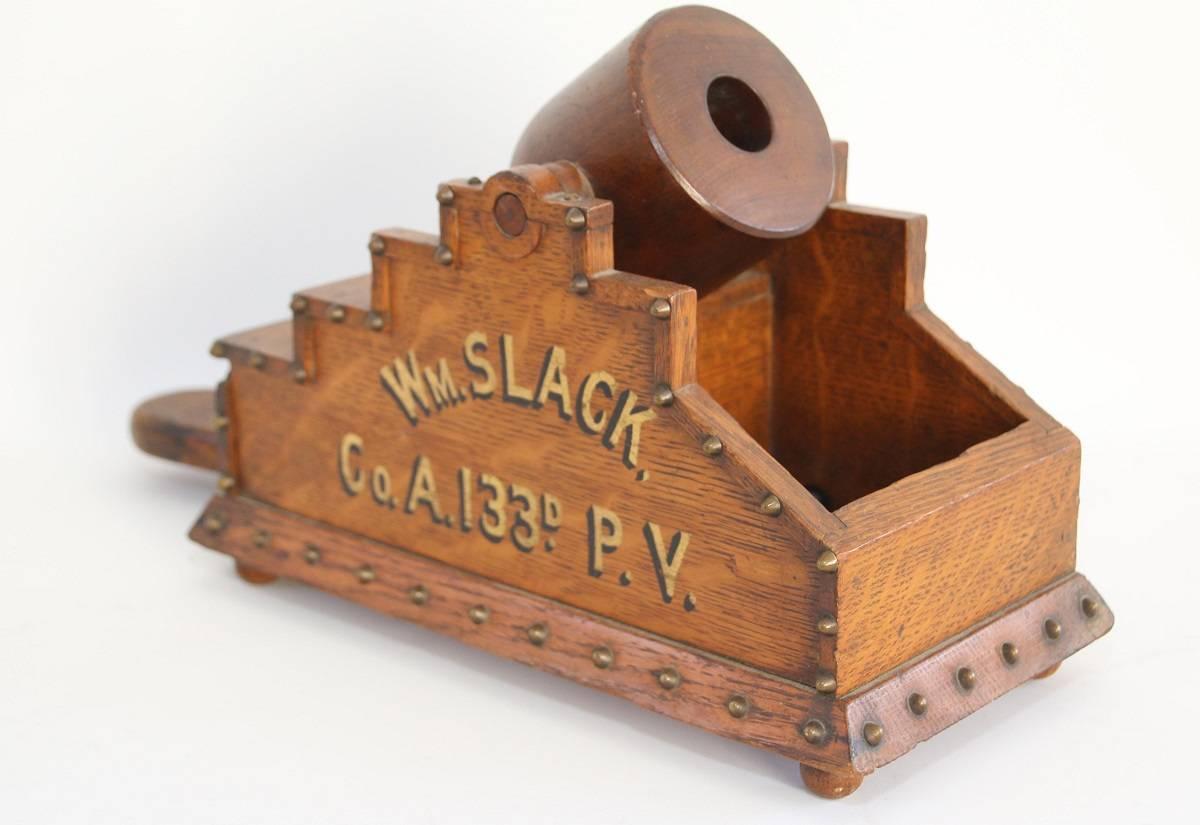 Civil War-era oak cannon-shaped voting or ballot box raised on four ball feet with nine white and fourteen black counters. The term ballot is derived from the Italian ballotta, meaning 
