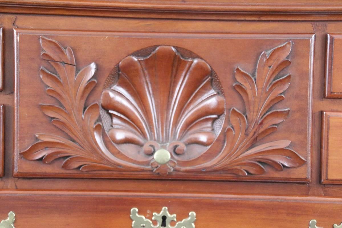 Cherry highboy in two parts having nine drawers on the top section and four on the bottom, both parts fitted with deep centre drawer having well developed concave shell and leaf carvings, sitting atop carved cabriole legs with acanthus carved knees.