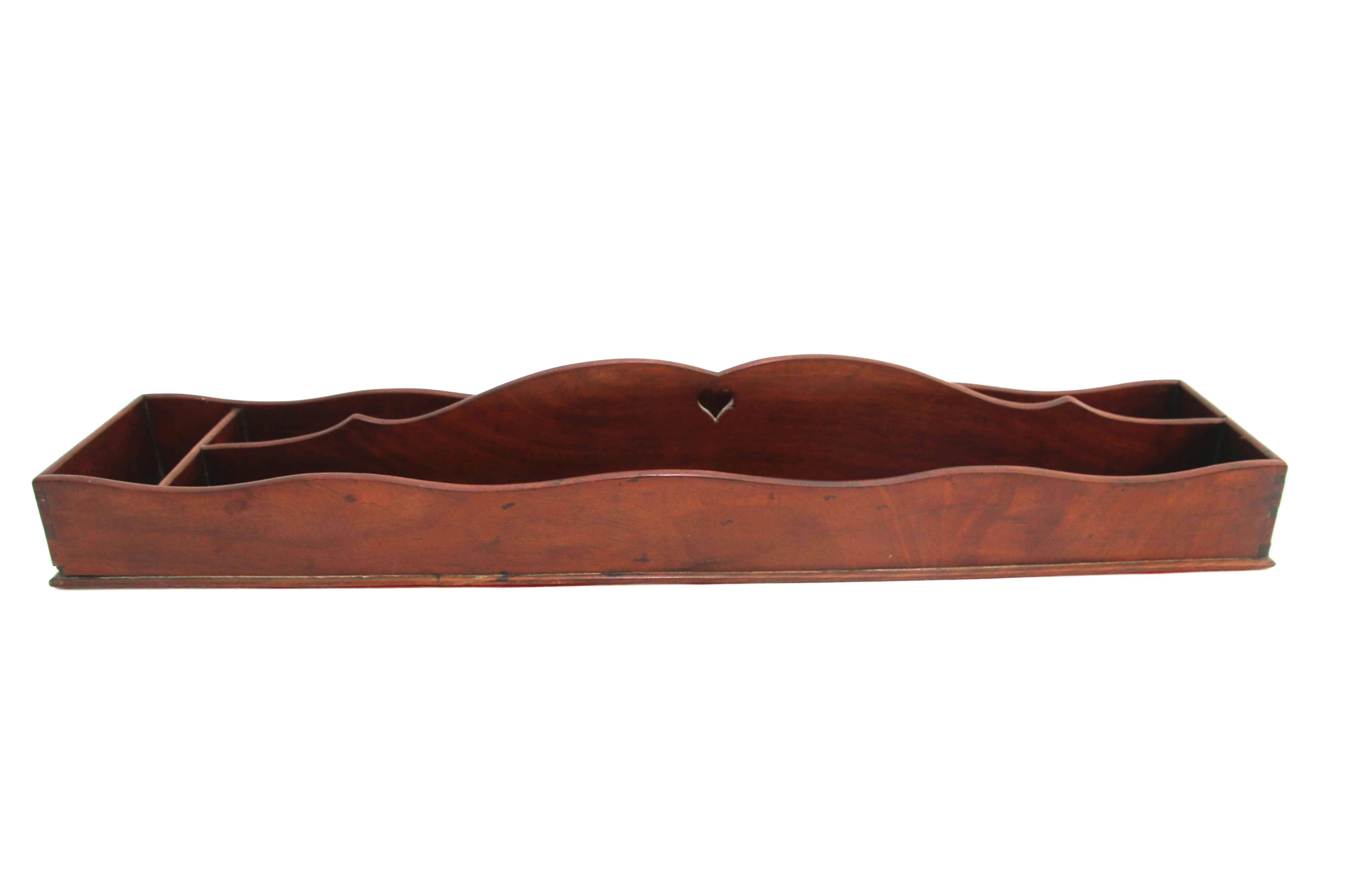 Long mahogany cutlery tray, 19th century, with pierced heart handle divider, dovetail construction, and end with narrow compartment. 

Red felt added to underside.

Minor loss at corner as noted in photograph.

Measures: 26.5 inches long by