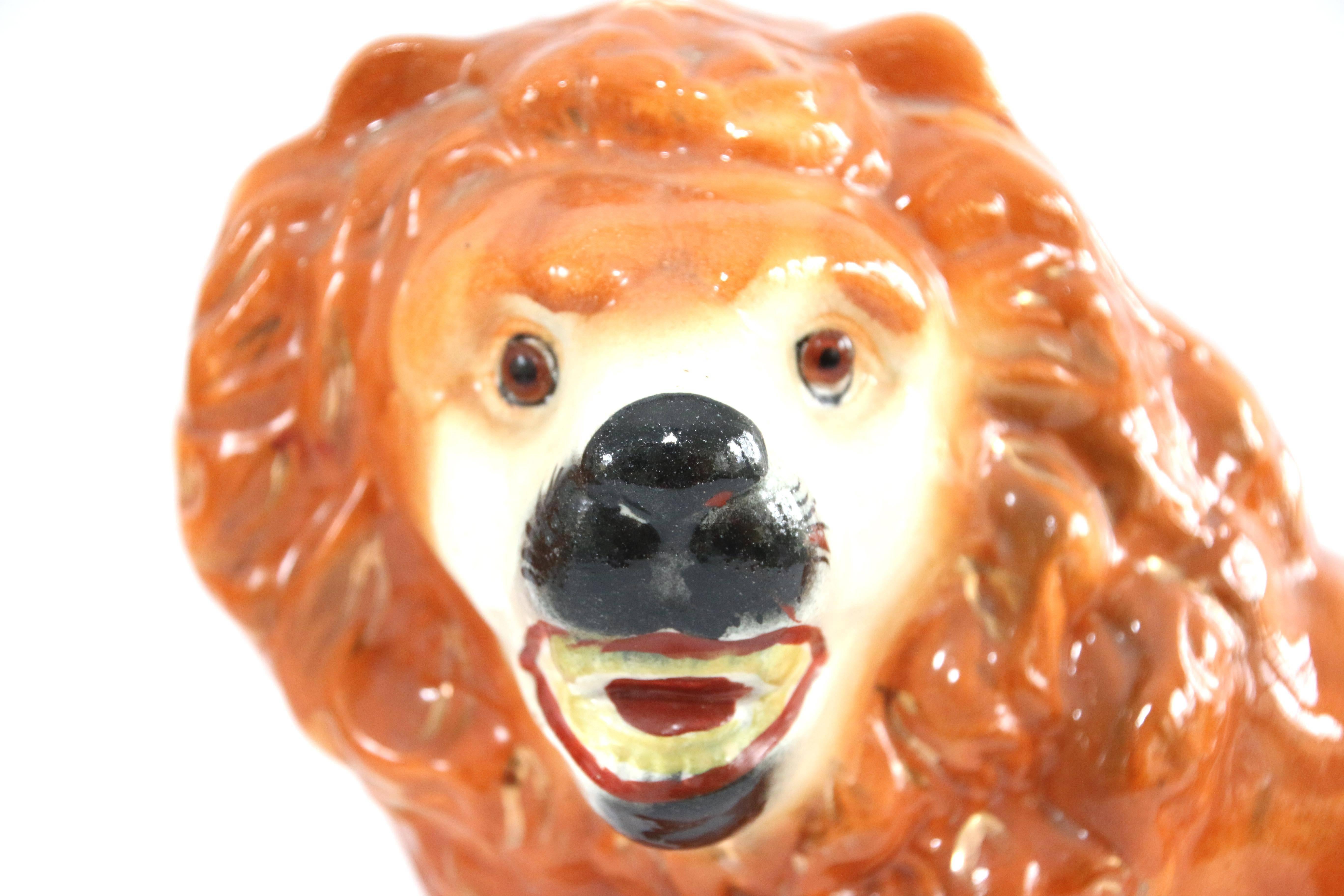 Pair of 19th century porcelain Staffordshire lions with glass eyes, circa 1870.
