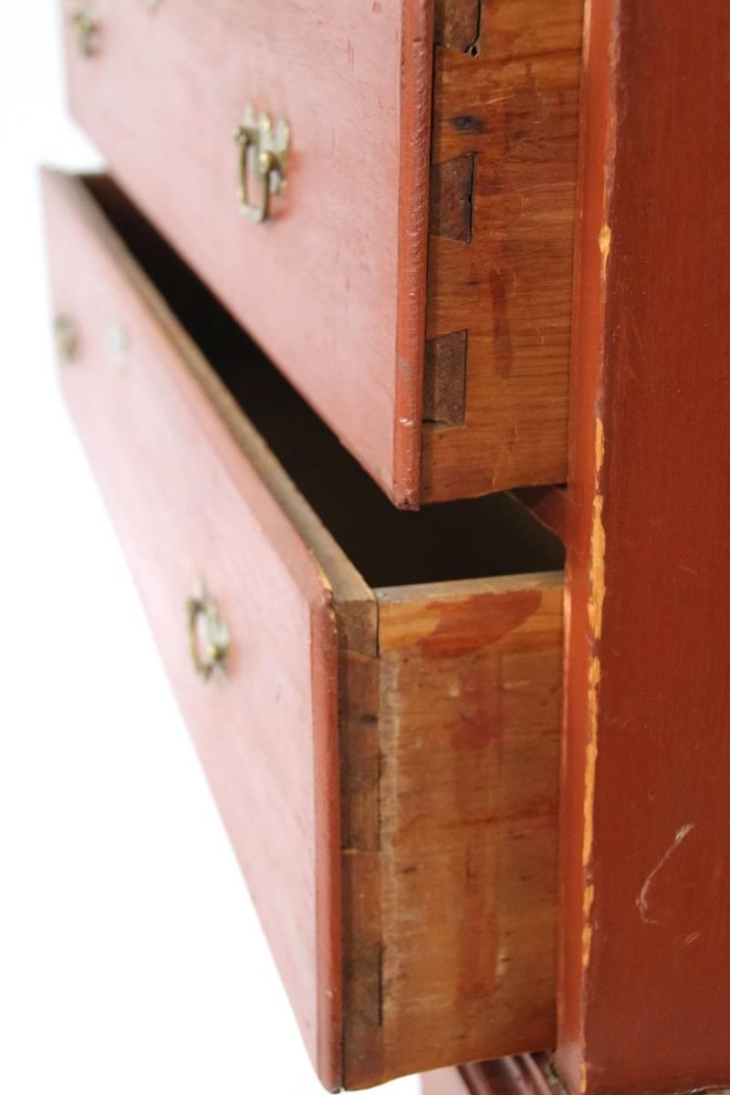 The snipe-hinged lift top concealing the chest over two drawers all raised on carved bracket feet with arched and carved skirt adorning the front.

New England, circa 1760.

Measure: 40.5 inches high by 39.5 inches wide by 17.75 inches