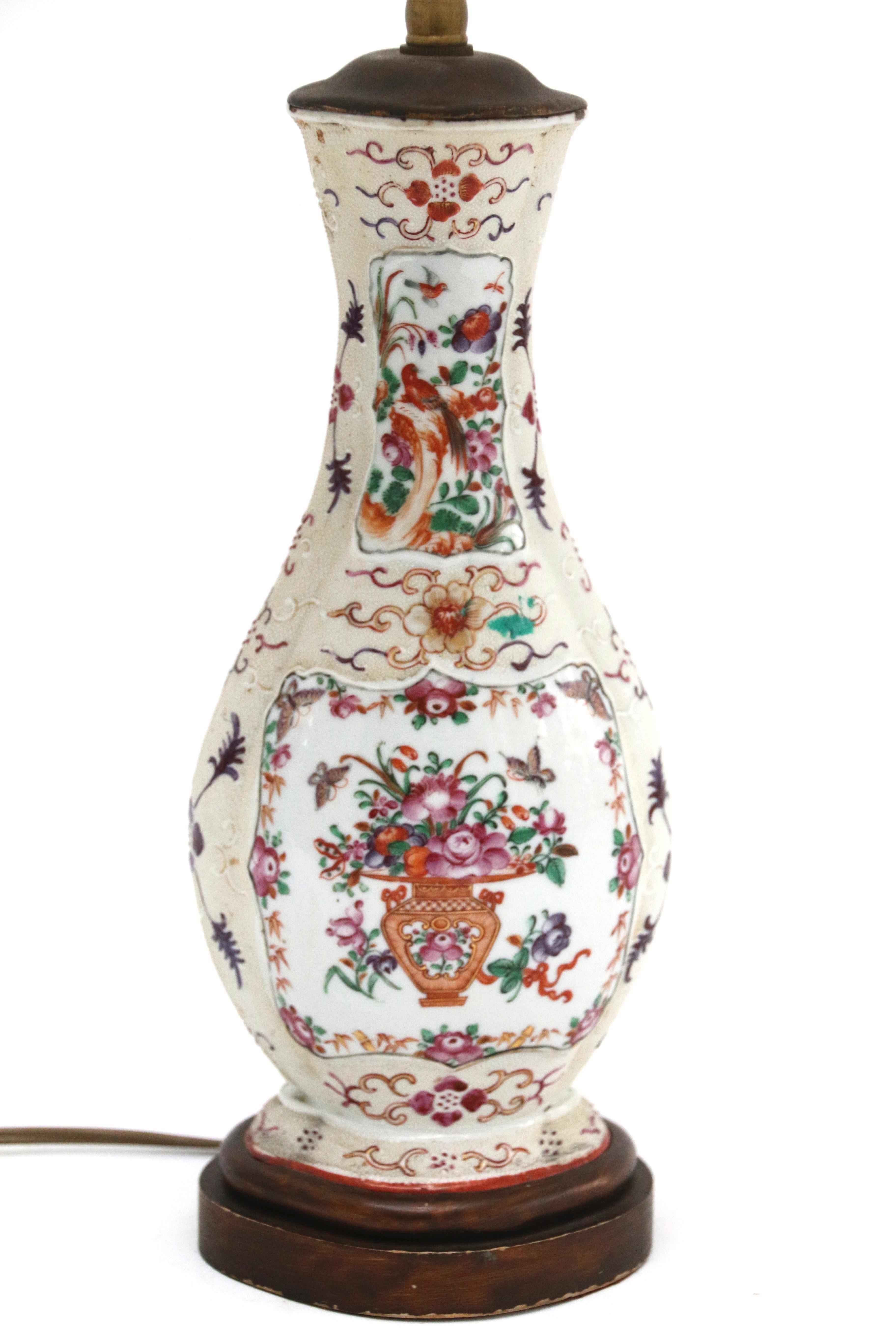 18th century Chinese export porcelain vase later fitted as a lamp and placed on wooden base. Predominantly red, purple and pink floral design on cream background. Vase is 11