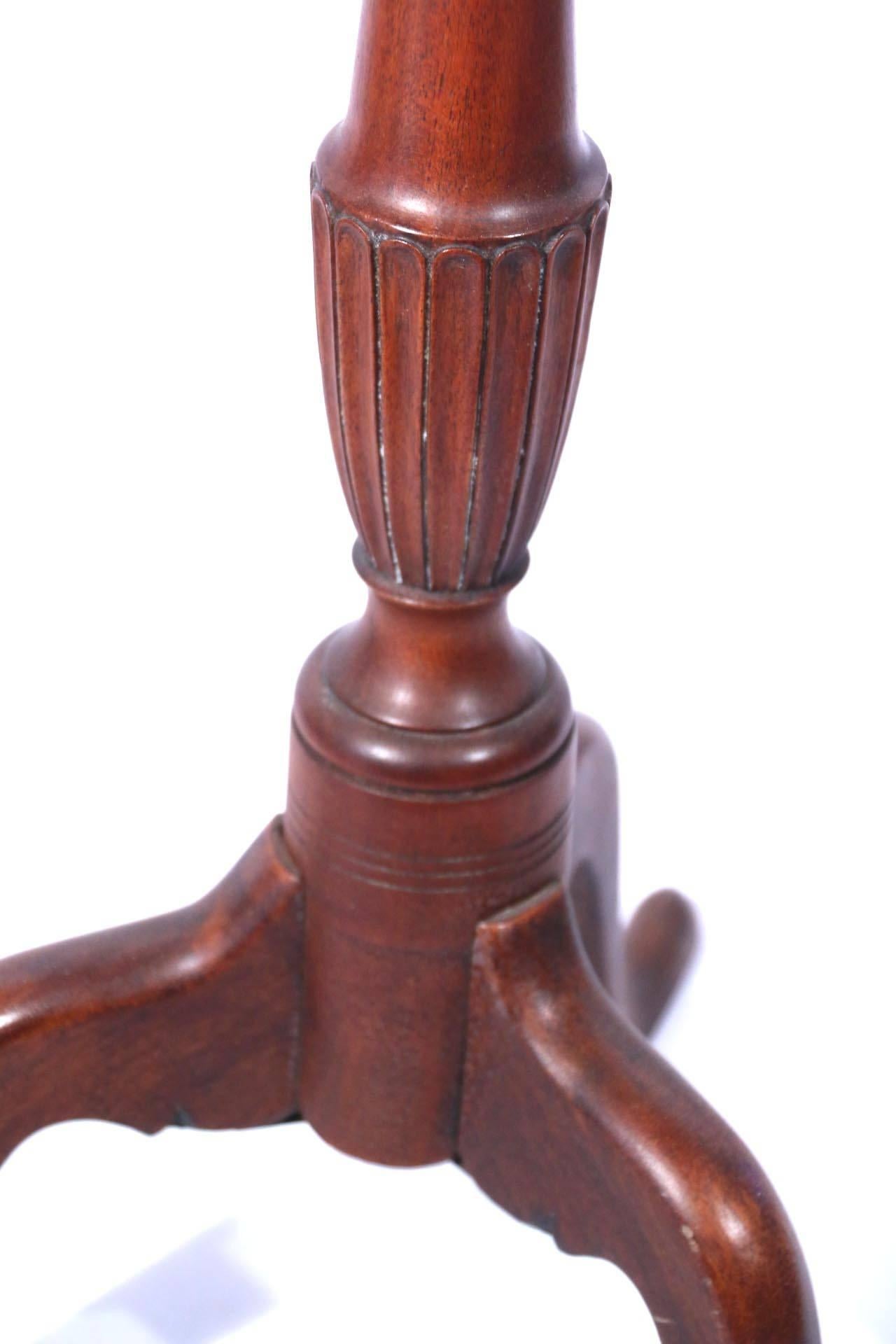Carved mahogany candlestand with molded octagonal tray top on a fluted vase-and ring-turned support on tripod cabriole leg base ending in pad feet. Refinished.