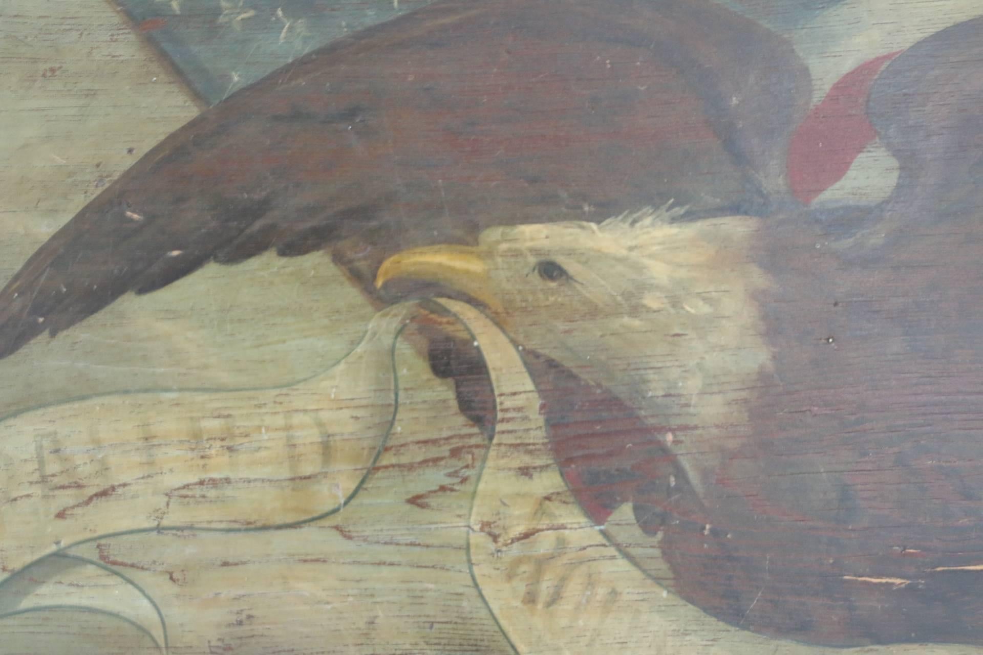 Rare pine wall plaque depicting an eagle clutching a flagpole with American flag holding a banner in beak, 